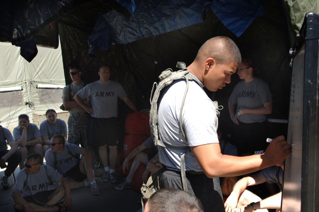 ELLSWORTH AIR FORCE BASE, S.D. -- Staff Sgt. Isaac Pardon-Varde, Army National Guard, 704th Chemical Company NCO in-charge of training, briefing soldiers on an upcoming decontamination simulation during the 2010 Golden Coyote exercise at Camp Lancer, Ellsworth Air Force Base, S.D., June 18.  The 704 CC is responsible for responding to chemical, biological, radiological and nuclear threats. (U.S. Air Force photo/Airman 1st Class Jarad Denton)