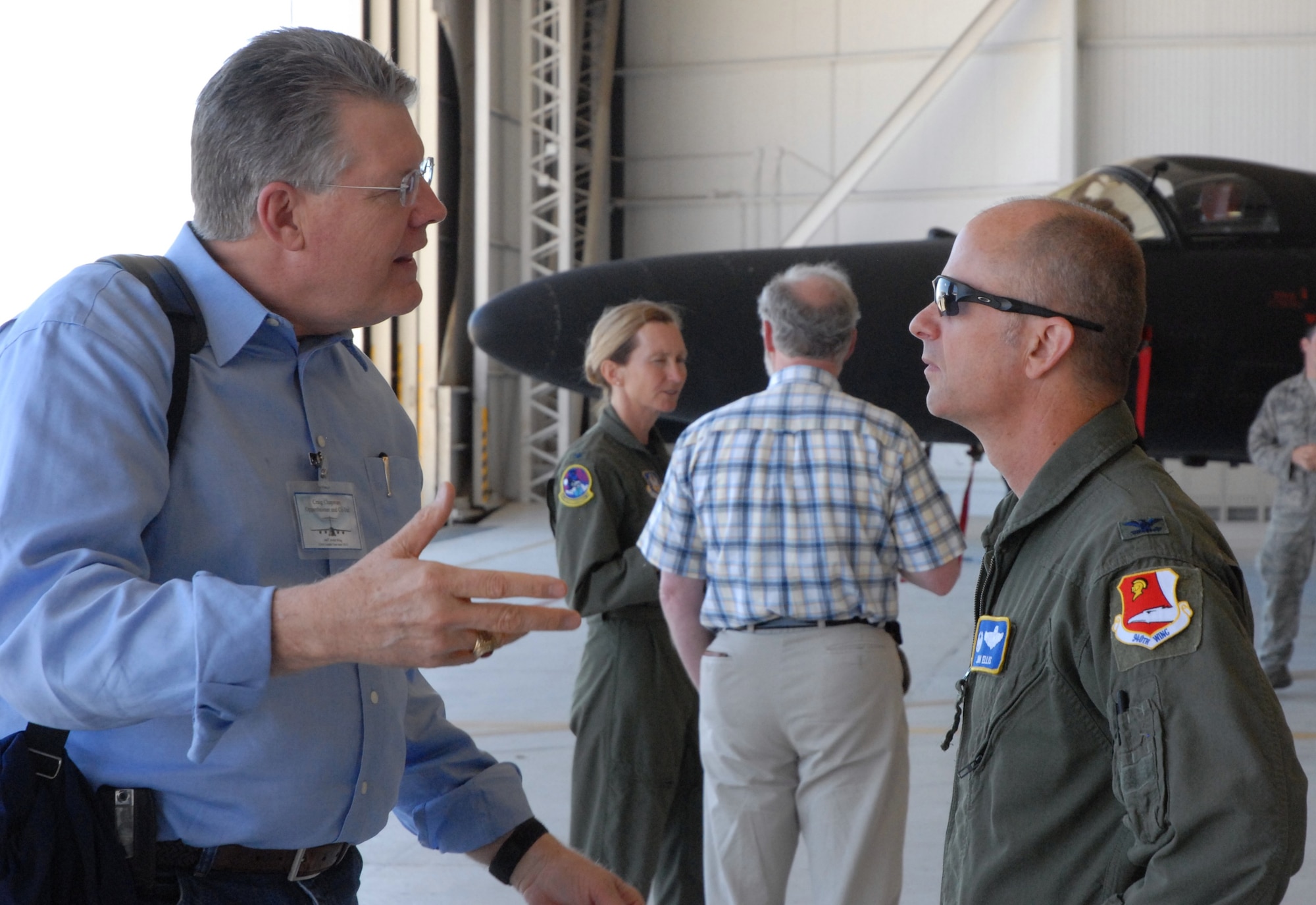 Col. Jon Ellis, 940 Operations Group Commander, listens to one of the guests.
