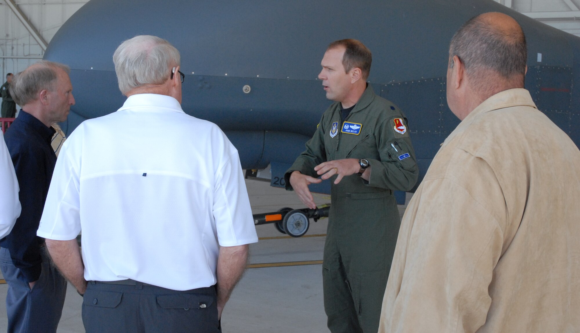 Lt. Col. John Welch, 13 Reconnaissance Squadron Commander, talks to the guests about the RQ-4 Global Hawk.