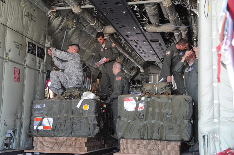 DYESS AIR FORCE BASE, Texas—Load crew members from the 40th Airlift Squadron, secure bundles on the C-130J Super Hercules June 17 as part of a 22-bundle mass container delivery system airdrop at Bronte Drop Zone over Bronte city to demonstrate the capabilities of the C-130J-model. The regular C-130 Hercules’ are only capable of carrying 16 bundles. The 317th Airlfit Group will be training more on this to help prepare them for deployments. In the course of two years all of the old C-130 Hercules’ will be replaced by the new J-model. (U.S Air Force photo/ Airman 1st Class Shannon Hall)