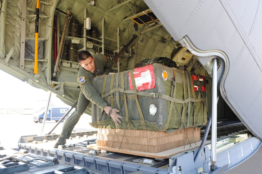 DYESS AIR FORCE BASE, Texas—Senior Airman Jason Ignacio, 40th Airlift Squadron, secures a bundle on the C-130J Super Hercules June 17 as part of a 22-bundle mass container delivery system airdrop at Bronte Drop Zone over Bronte city to demonstrate the capabilities of the C-130J-model. The regular C-130 Hercules’ are only capable of carrying 16 bundles. The 317th Airlfit Group will be training more on this to help prepare them for deployments. In the course of two years all of the old C-130 Hercules’ will be replaced by the new J-model. (U.S Air Force photo/ Airman 1st Class Shannon Hall)