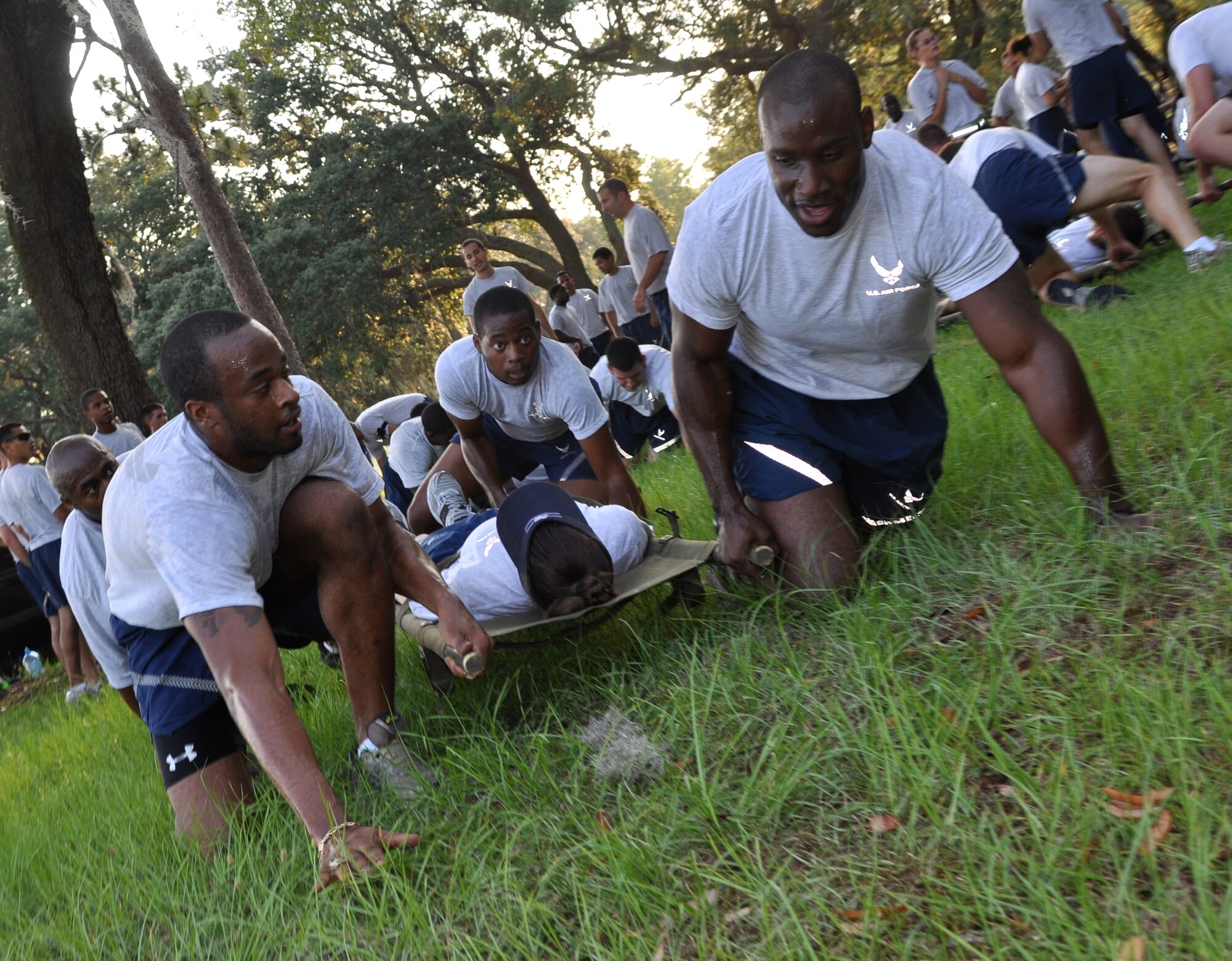 (Far right) Tech. Sgt. Larue Holliday, 96th Air Base Wing Knowledge Operations Management, and other members from the Elite Fit group pull a "patient" to safety at Station 1 Challenge area. The litter crawl was part of the 96th Air Base Wing Fitness Event held June 18. (U.S. Air Force photo/Staff Sgt. Stacia Zachary)