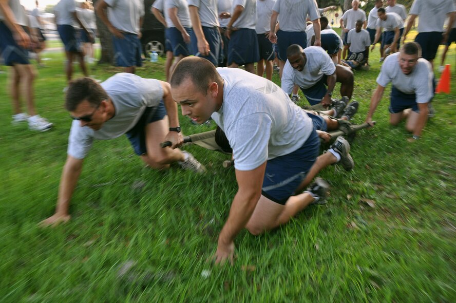 First Lt. Zachary Mason, 96th Comptroller Squadron, helps pull a "patient" to safety with team members (far left) Col. Bruce McClintock, 96th Air Base Wing Commander, and (back right) Chief Master Sgt. Thomas Westermeyer, 96th ABW Command Chief, as part of the challenge segment of the wing fitness event June 18.