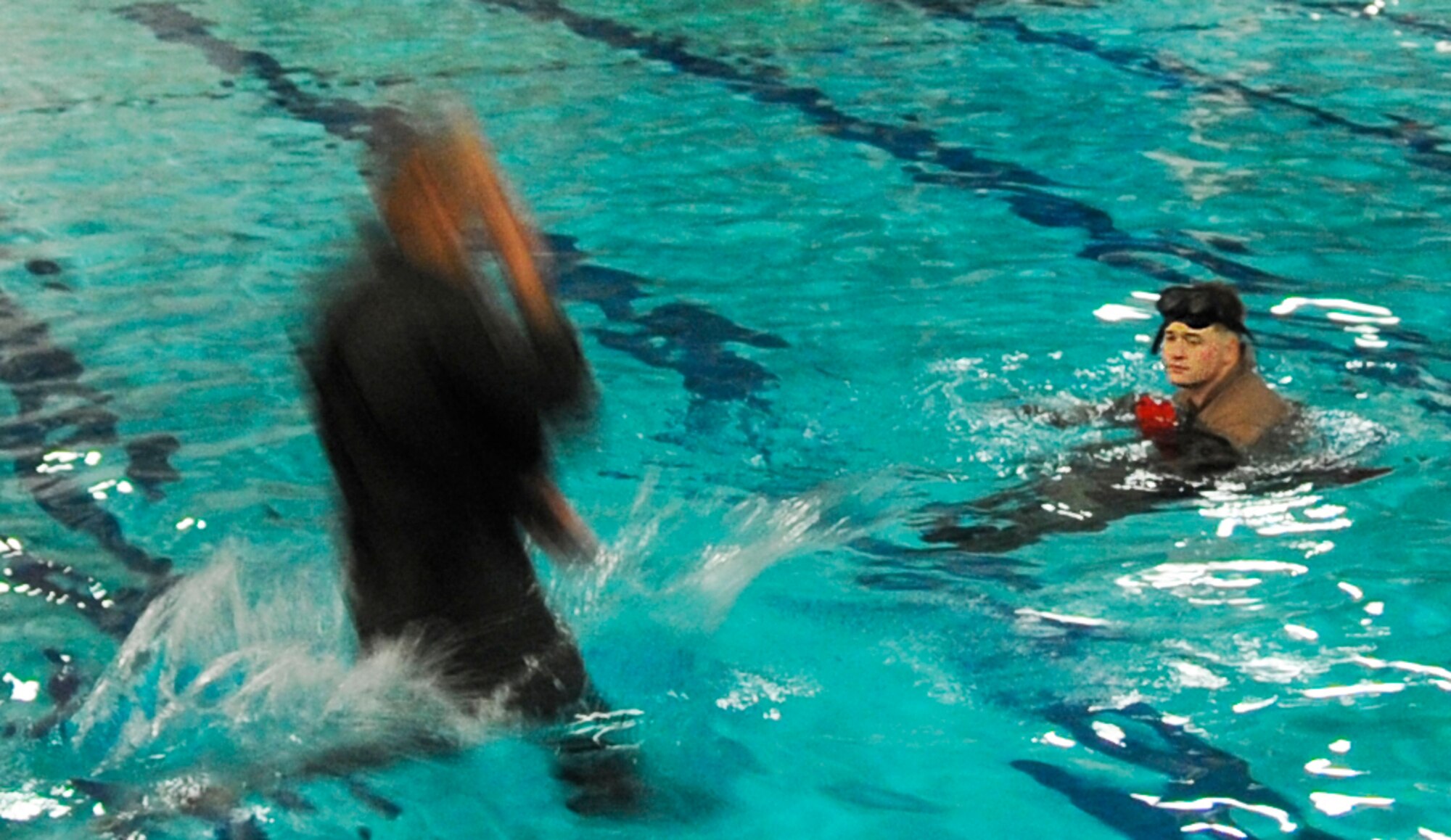 Senior Airman Parker Hudson (right), oversees water survival training in the base pool June 9, 2010 at Fairchild Air Force Base, Wash. Airman Hudson is an instructor with the 22nd Training Squadron. Water survival courses were relocated to Fairchild AFB when oil was discovered in the Gulf of Mexico training area. (U.S. Air Force photo/Staff Sgt. Chad Watkins)

