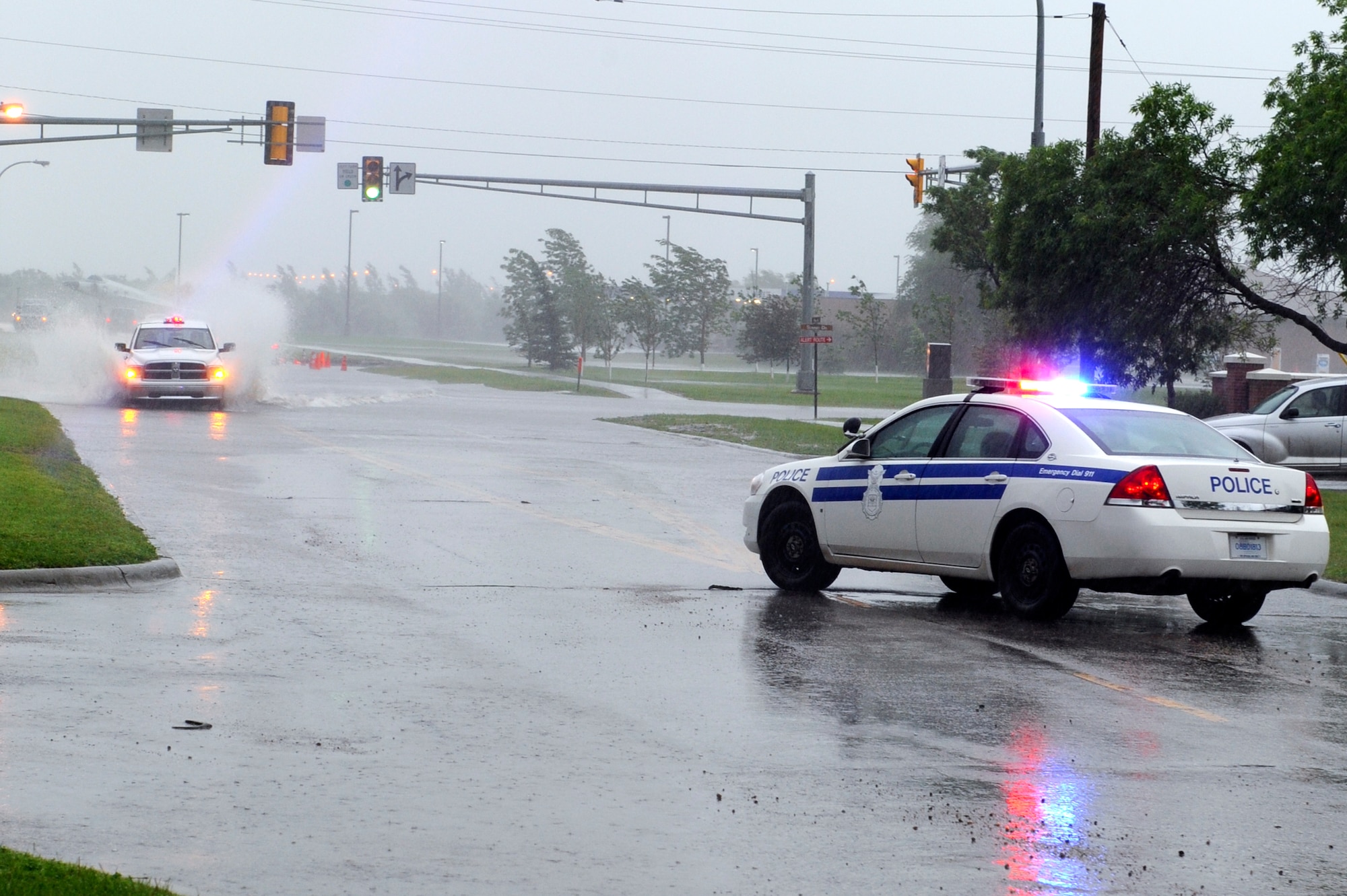 MINOT AIR FORCE BASE, N.D. – A 5th Security Forces Squadron patrol vehicle blocks the east bound lane of Missile Avenue here 17 June.  The 5th SFS closed numerous intersections on base in the late afternoon hours due to standing water from heavy rain produced by severe thunderstorms that moved through the area.  Minot AFB received almost 2 inches of rain in a 3 hour period.  (U.S. Air Force photo by Master Sgt. Michael Gaddis)