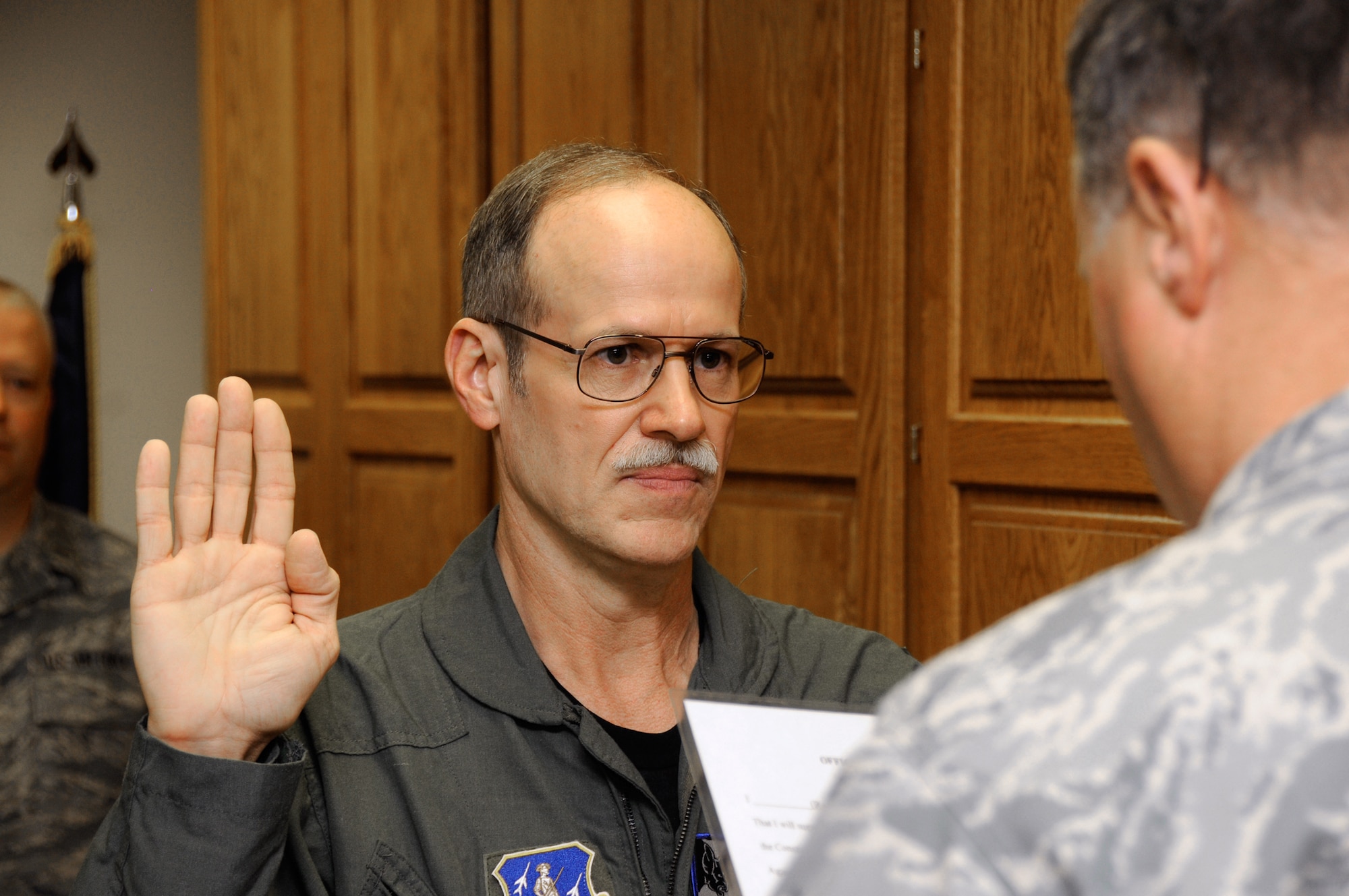 Maj. (Dr.) Glenn Harden, a physician from Sioux City, Iowa, is sworn into the Air National Guard May 1, 2010, at the 185th Air Refueling Wing in Sioux City. Doctor Harden will work as the flight surgeon at the wing's medical clinic. (U.S. Air Force photo/Tech. Sgt. Oscar Sanchez) 