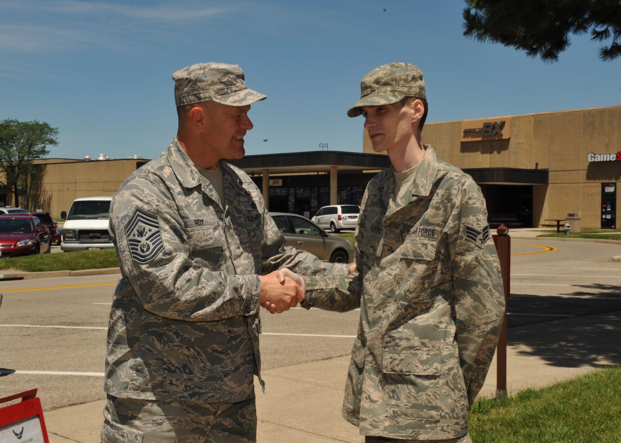 Chief Master Sgt. of the Air Force James A. Roy meets with Senior Airman Tre Porfirio, a cyber transport journeyman from the 88th Communications Group, during his visit to Wright-Patterson Air Force Base, Ohio, June 10.  Airman Porfirio was shot and severely injured while deployed to Afghanistan and has been recovering at Wright-Patterson AFB and Walter Reed medical facility. (U.S. Air Force photo by Tech. Sgt. Brendan Kavanaugh)