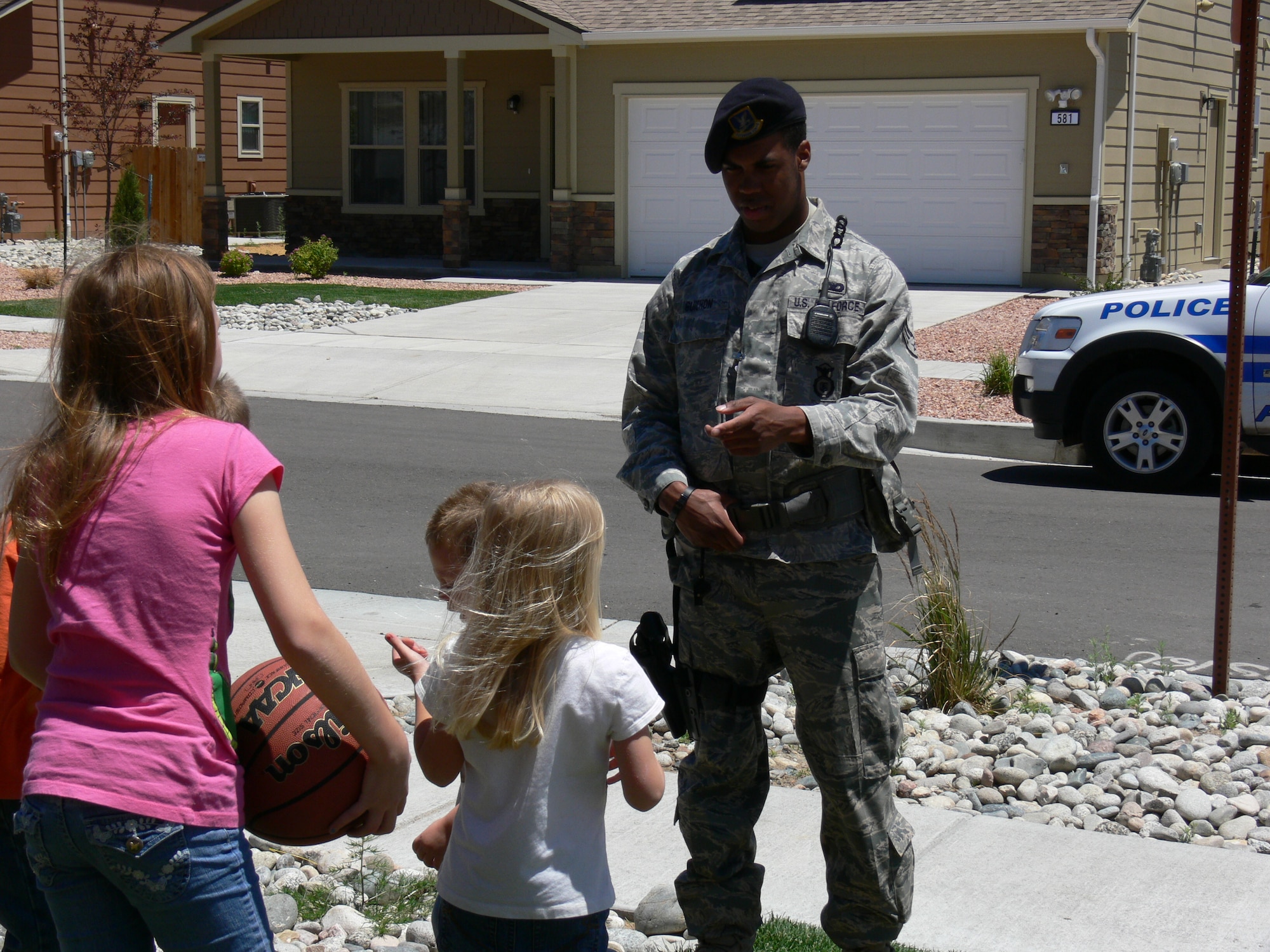 Senior Airman R. Jamal Guichon, 21st Security Forces Squadron, stops to talk with Peterson Air Force Base housing residents June 15. Residents have likely noticed an increased presence of security forces. The new neighborhood patrols are part of the 21st SFS integrated defense plan which calls for security forces to be more visible on base. (U.S. Air Force photo/Monica Mendoza)