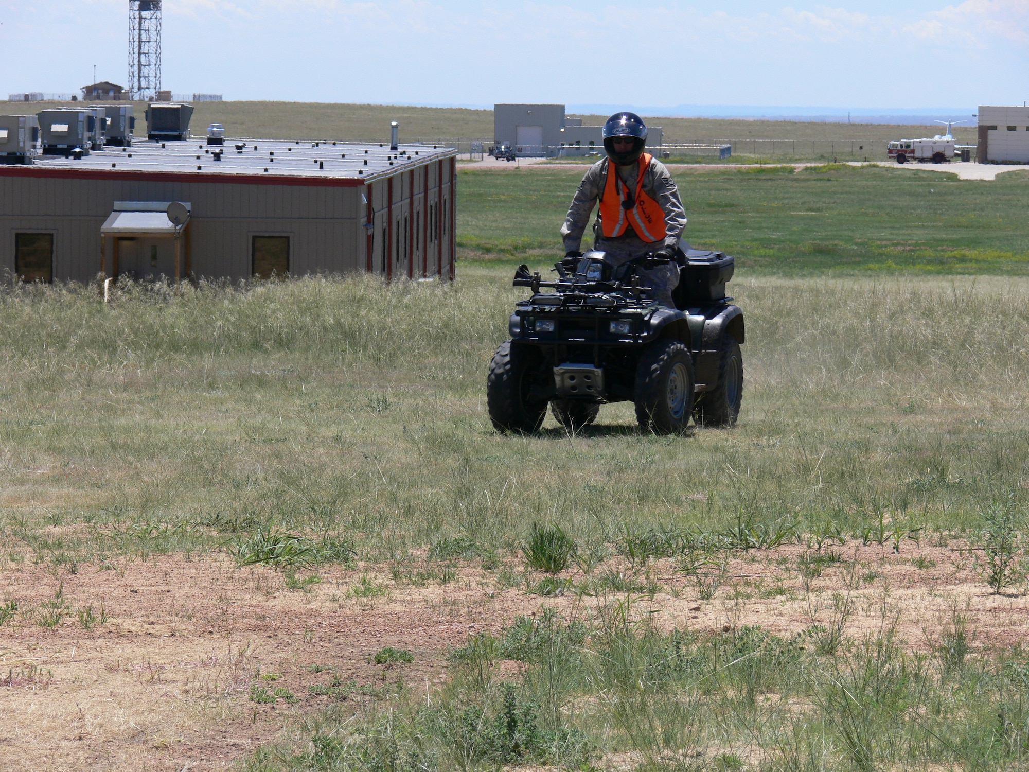 Staff Sgt. Steven Howell, 21st Security Forces Squadron, patrols on an all-terrain vehicle near the Peterson Air Force Base flightline June 15. The ATV patrol is new and allows security forces to get into areas where a squad car cannot go. It’s part of the new integrated defense plan designed by the 21st SFS. The squadron is the first in Air Force Space Command to have a published integrated defense plan under the new Air Force Instruction. (U.S. Air Force photo/Monica Mendoza)