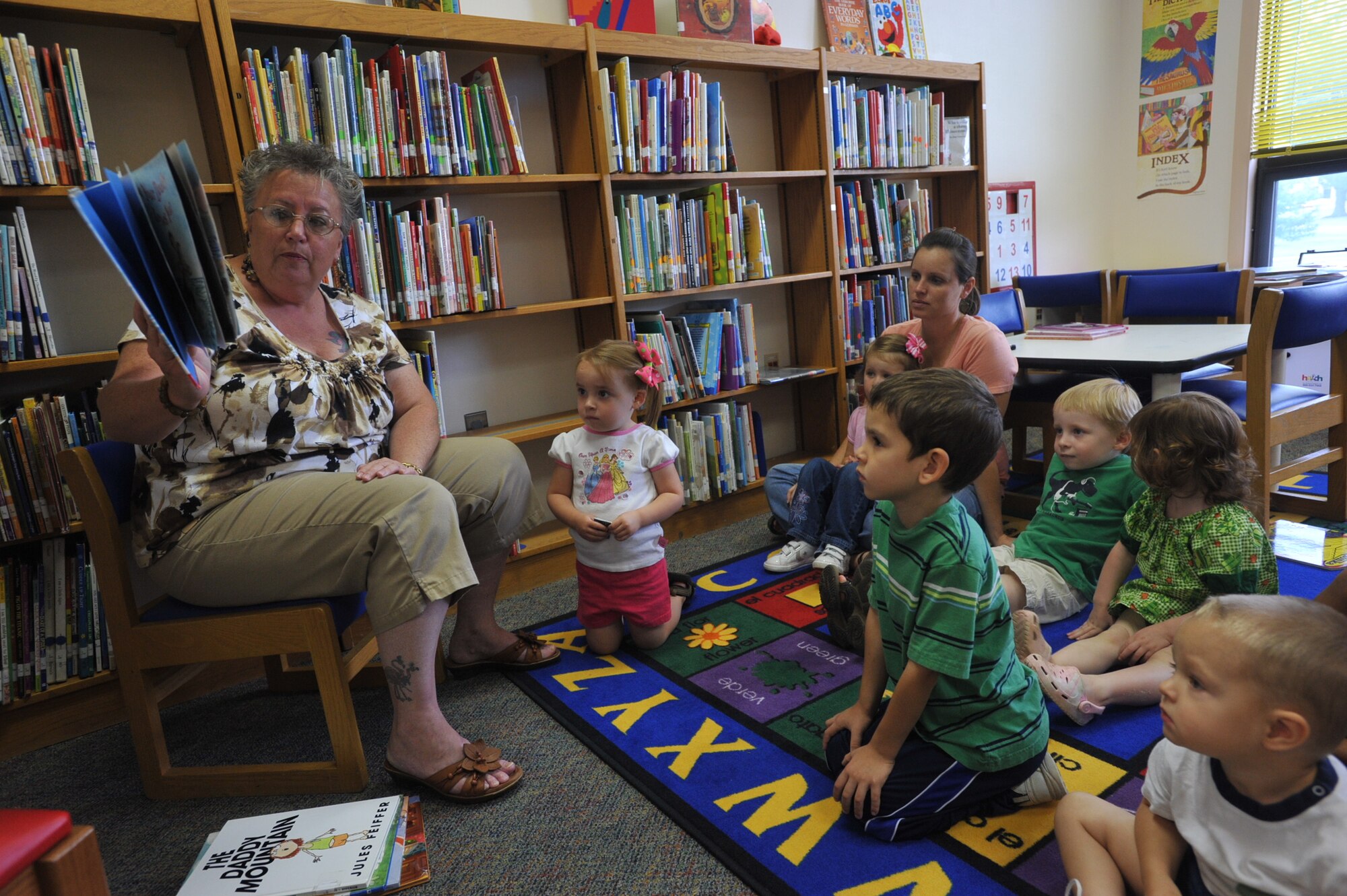 Base Library Director, Ms. Cheryl Gritton, reads to children during "Story Time," which is offered twice a week.