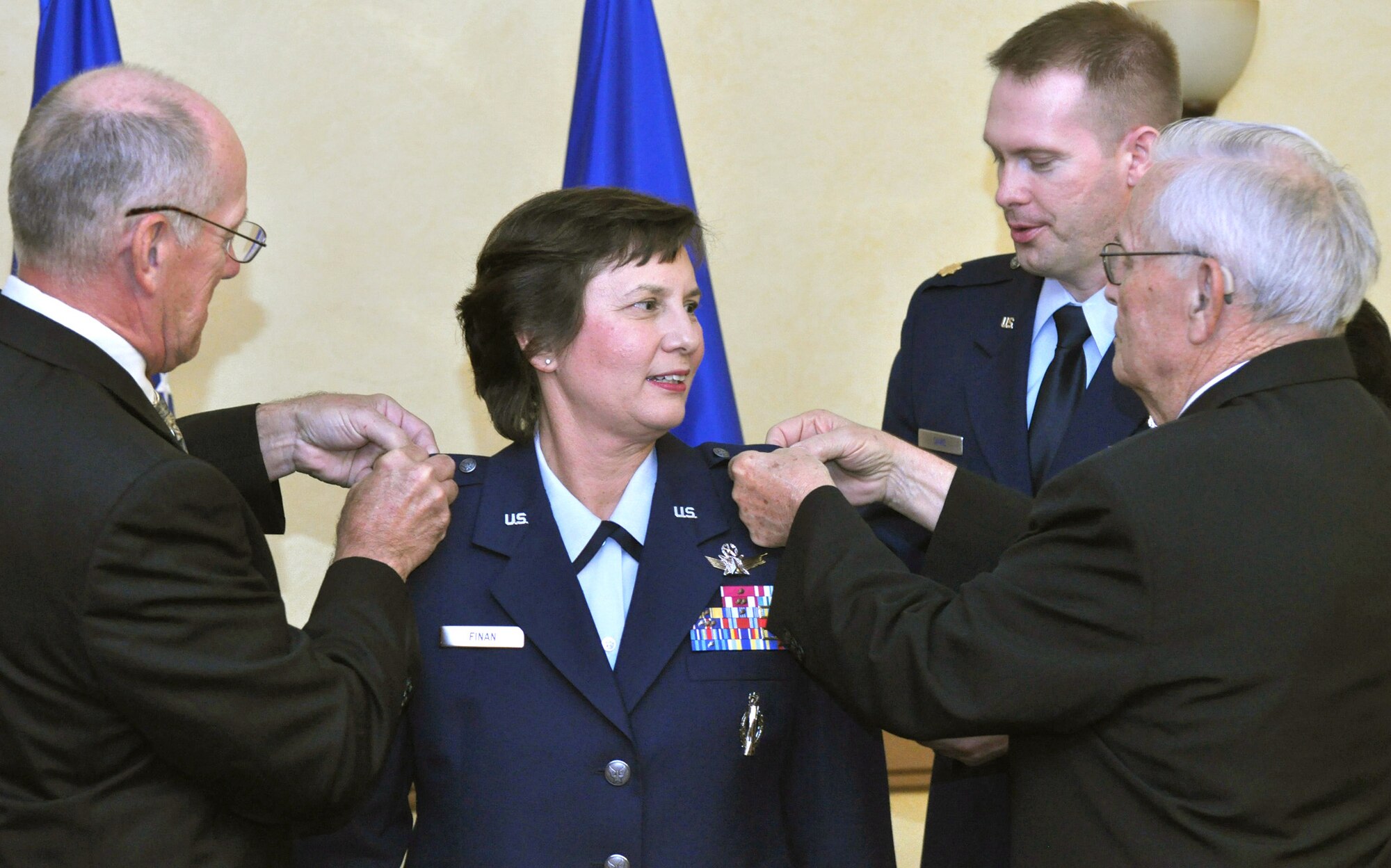 Retired Col. Chuck Finan (left), husband of Brig. Gen. Sandra Finan, and Delmar Chase, the general's father, pin handmade brigadier general's stars on the general at her promotion ceremony June 15, 2010, at Barksdale Air Force Base, La. General Finan is the Air Force Global Strike Command Inspector General. (U.S. Air Force photo/Master Sgt. Corey Clements)
