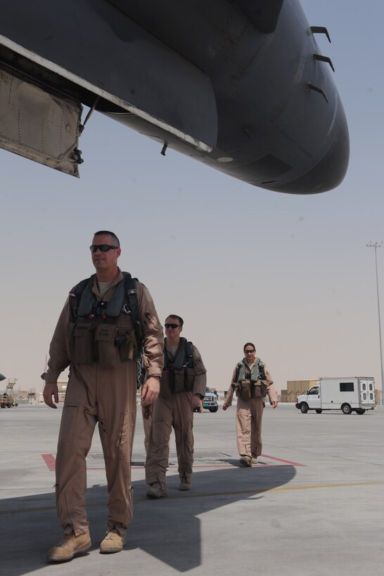 Lt. Col. Steve Beasley (front), Capt. Chris Winklepleck and Capt. Miranda Brasko, 34th Expeditionary Bomb Squadron pilots, arrive to board B1-B Lancer aircraft tail number 5087 prior to its reaching the 10K flight hour mark at a non-disclosed Southwest Asia location, June 12, 2010. Colonel Beasley is also the 34 EBS commander. (U.S. Air Force photo by Tech. Sgt. Michelle Larche)[RELEASED]