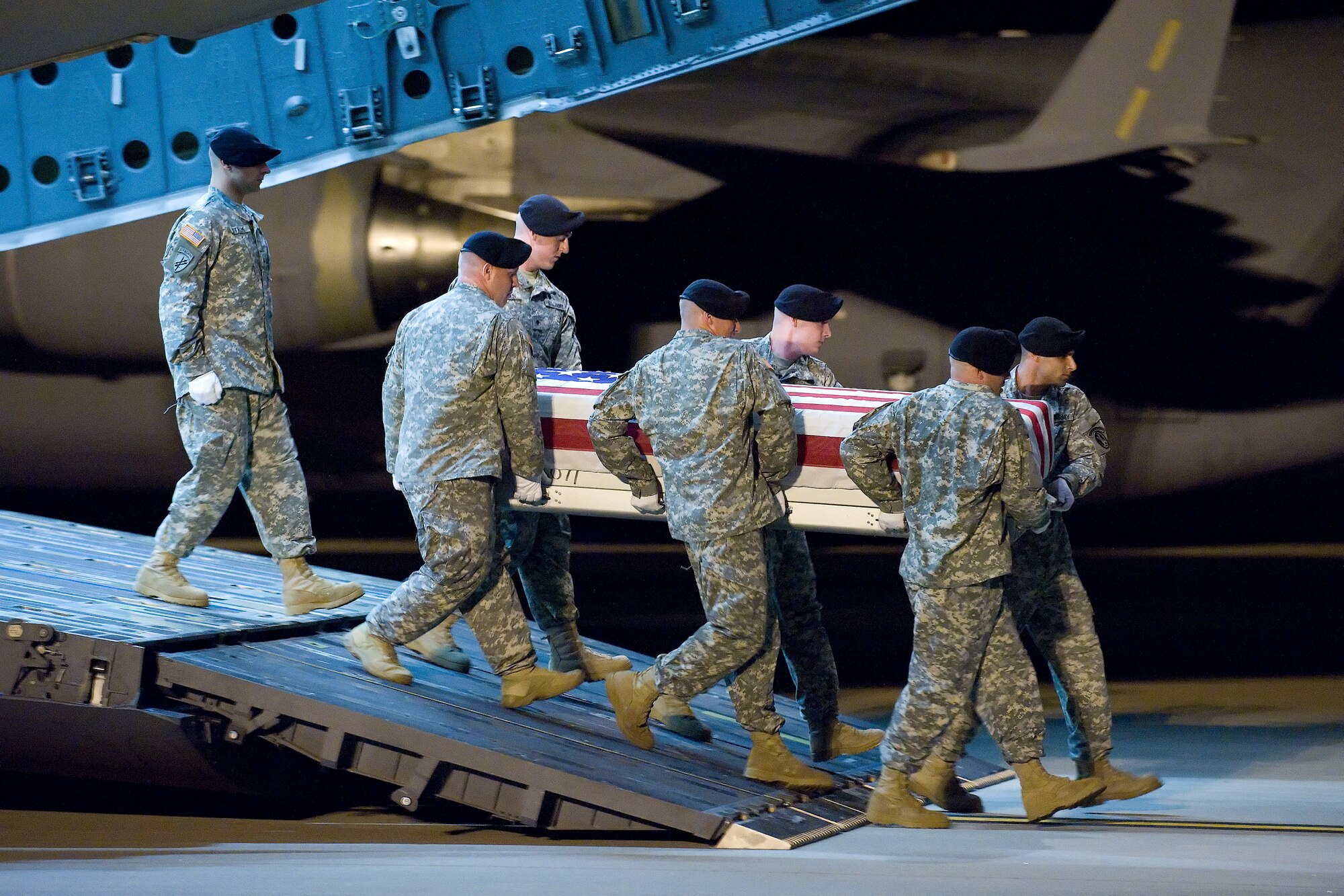 13 June 2010  USAF Photo by Jason Minto.  A U.S. Army carry team transfers the remains of Army SPC Christian M. Adams of Sierra Vista, AZ at Dover Air Force Base, Del., June 13, 2010.  