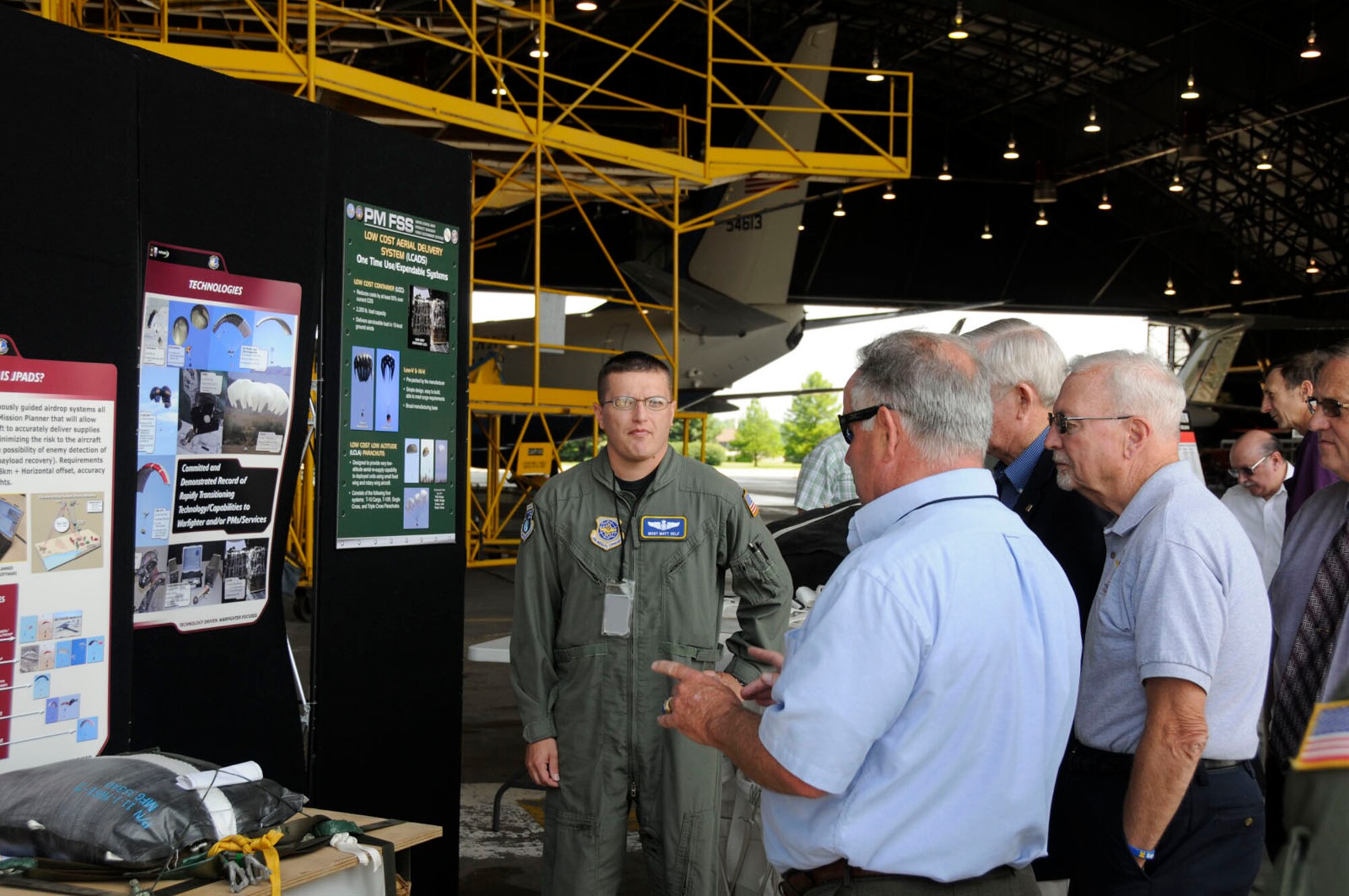 Master Sgt. Matthey Self, AMC command tactics loadmaster explains the Low Cost Aerial Delivery System here Thursday. AMC teamed up with the Missouri Air National Guard and U.S. Army Natick Soldier Center to showcase  how their joint partnership is  improving aerial delivery, increasing airdrop options, enhancing mission flexibility and more accurately getting supplies and equipment to the warfighters when and where they need them.  (U.S. Air Force photo/Staff Sgt. Brian Ellis)