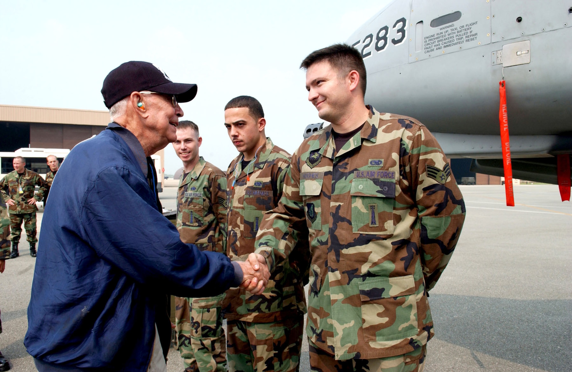 Generations connect: Air Force Korean War hero, POW and double ace Col. Harold Fischer greets 51st Fighter Wing personnel at Osan Air Base, Republic of Korea, in 2007. Fischer's story is highlighted in the Korean War Gallery at the National Museum of the U.S. Air Force. (U.S. Air Force photo)