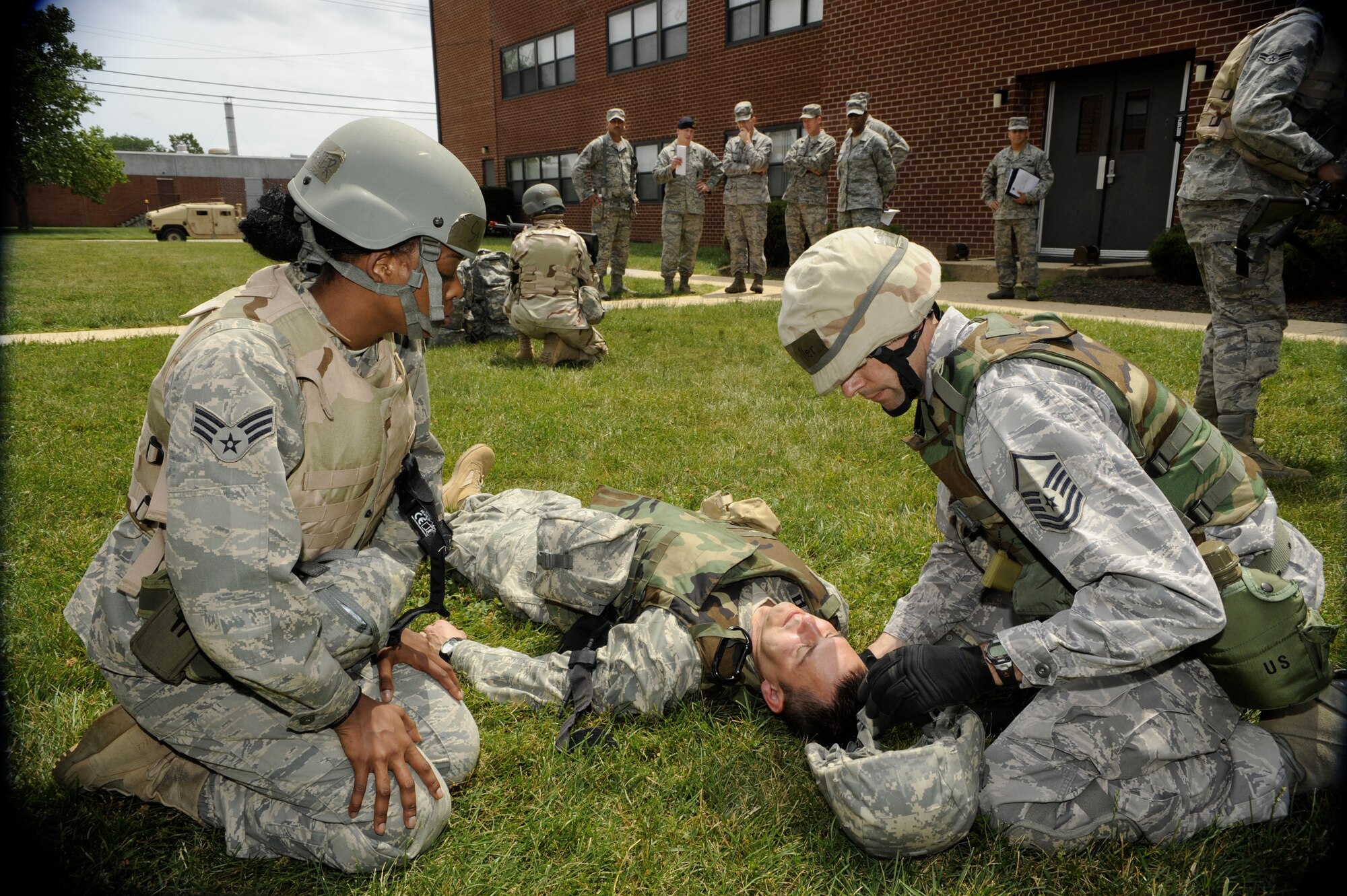 Students from the U.S. Air Force Expeditionary Center at Joint Base
McGuire-Dix-Lakehurst, N.J., perform combat first aid on a simulated
casualty while Chief Master Sgt. Robert Tappana, Air Education and Training
Command command chief master sergeant looks on with other members of EC
leadership June 16.  Chief Tappana visited the Expeditionary Center to get a
first-hand look at how the organization conducts pre-deployment training for
Airmen preparing to deploy to support ongoing expeditionary operations.
(U.S. Air Force photo by Carlos Cintron/Released)
