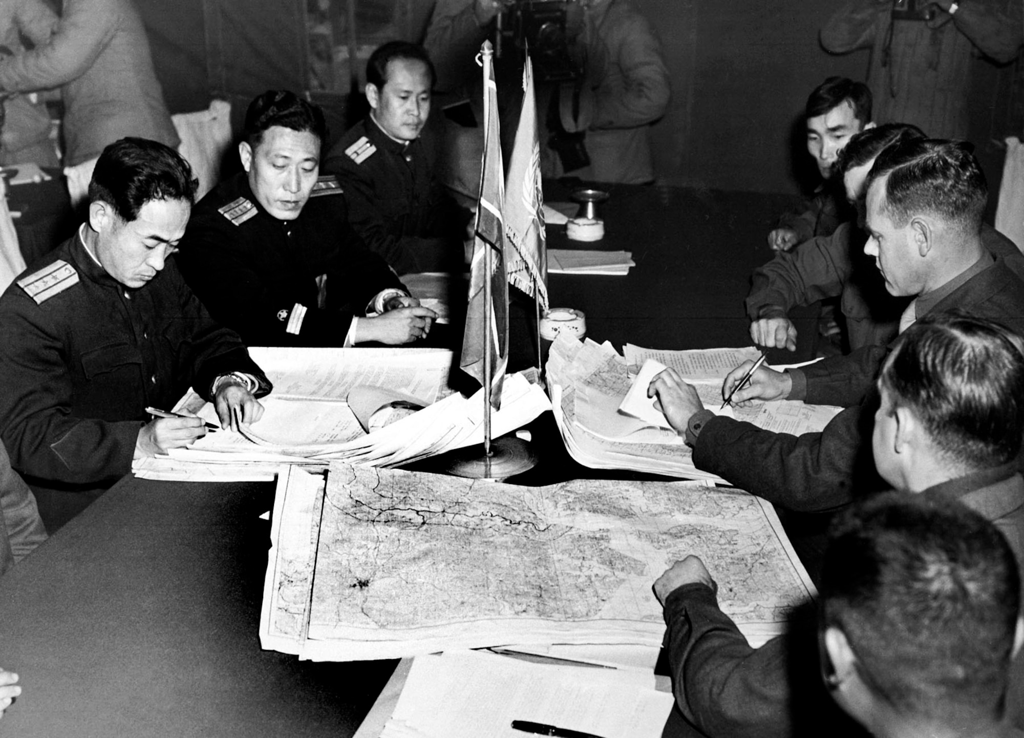 North Korean Army officers and U.S. military representatives initial maps defining the future Demilitarized Zone or DMZ at Panmunjom, October 1951. (U.S. Air Force photo)