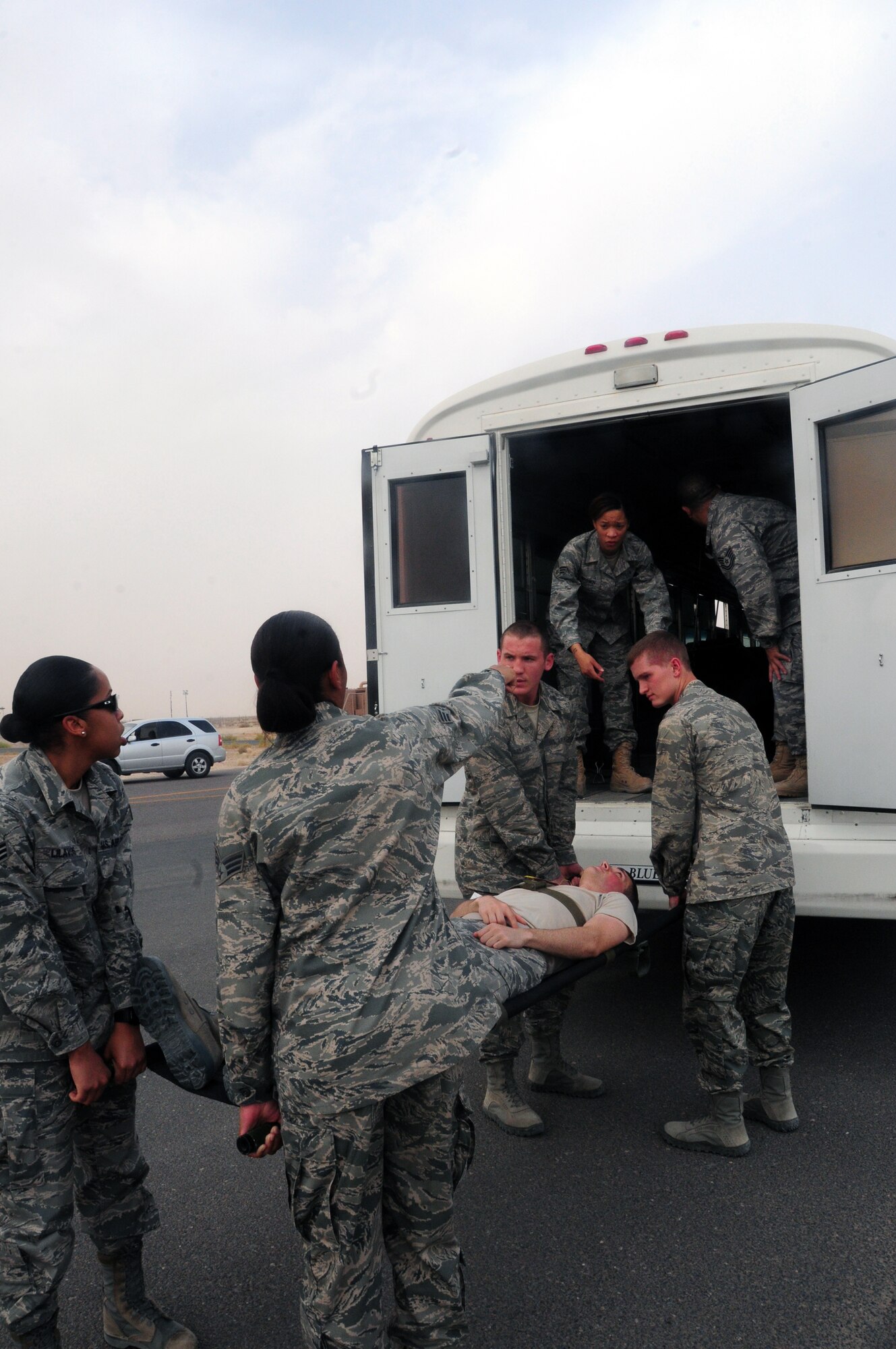 SOUTHWEST ASIA - U.S. Air Force Airmen from the 386th Expeditionary Medical Group load a mock patient into an emergency response vehicle, with the assistance of U.S. Air Force Academy cadets, to be transported to the Contingency Aeromedical Staging Facility here June 18, 2010 during a Major Accident Response Exercise at an undisclosed air base. The 386th AEW conducts base exercises to ensure the wing's ability to safely and successfully respond to major accidents. (U.S. Air Force photo by Staff Sgt. Lakisha A. Croley/Released)