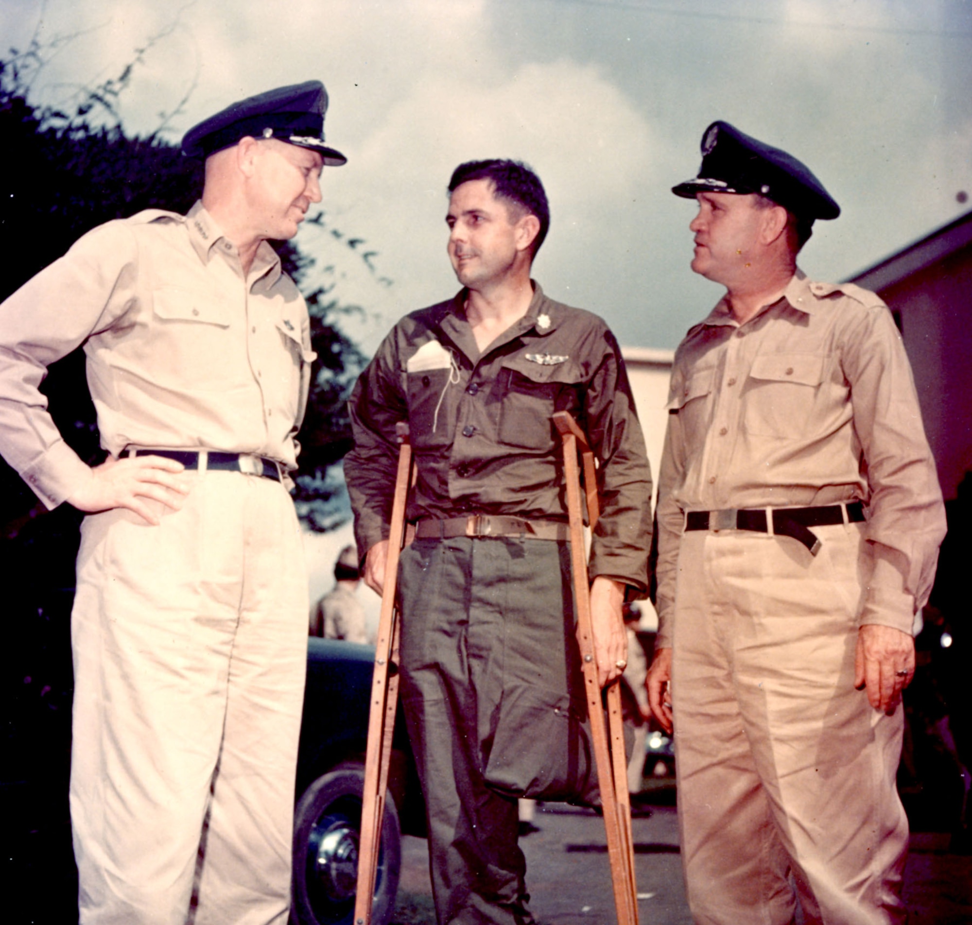 Gen. Otto P. Weyland, Far East Air Forces commander (left) and Surgeon Col. Jesse R. Grace (right) greet Lt. Col. Thomas Harrison, recently released during Operation Big Switch, September 1953. (U.S. Air Force photo)