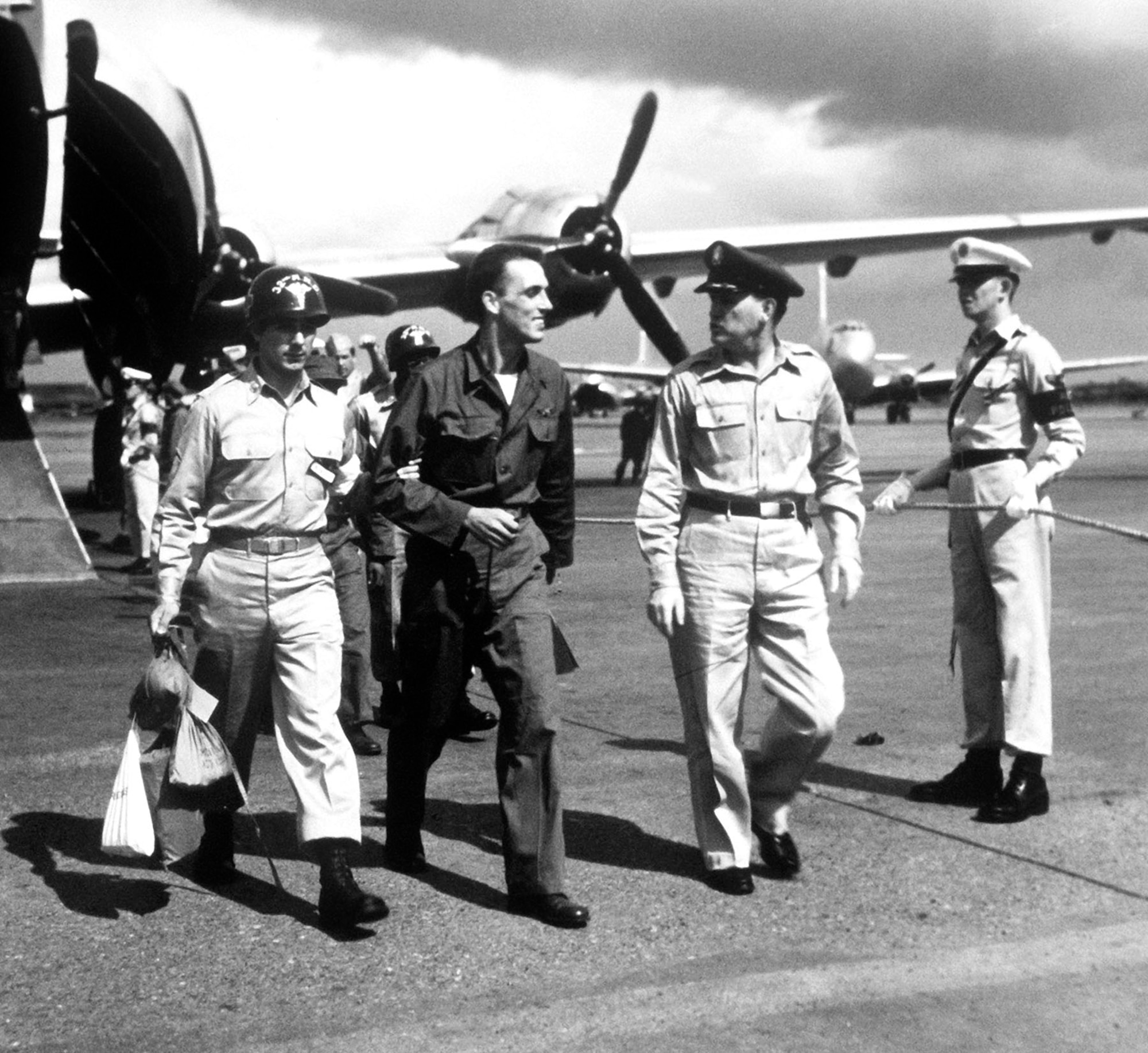 One of the first Air Force POWs to return to Japan in Operation Big Switch was Staff Sgt. Robert M. Wilkins (center). He is shown arriving in Japan after the 4-and-a-half hour flight from Korea, Aug. 18, 1953.  (U.S. Air Force photo)