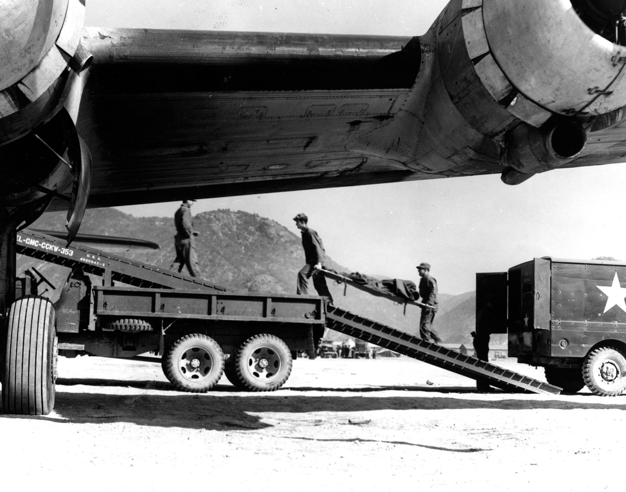 Airmen carry litter patients up truck ramps and into transport aircraft. (U.S. Air Force photo)
