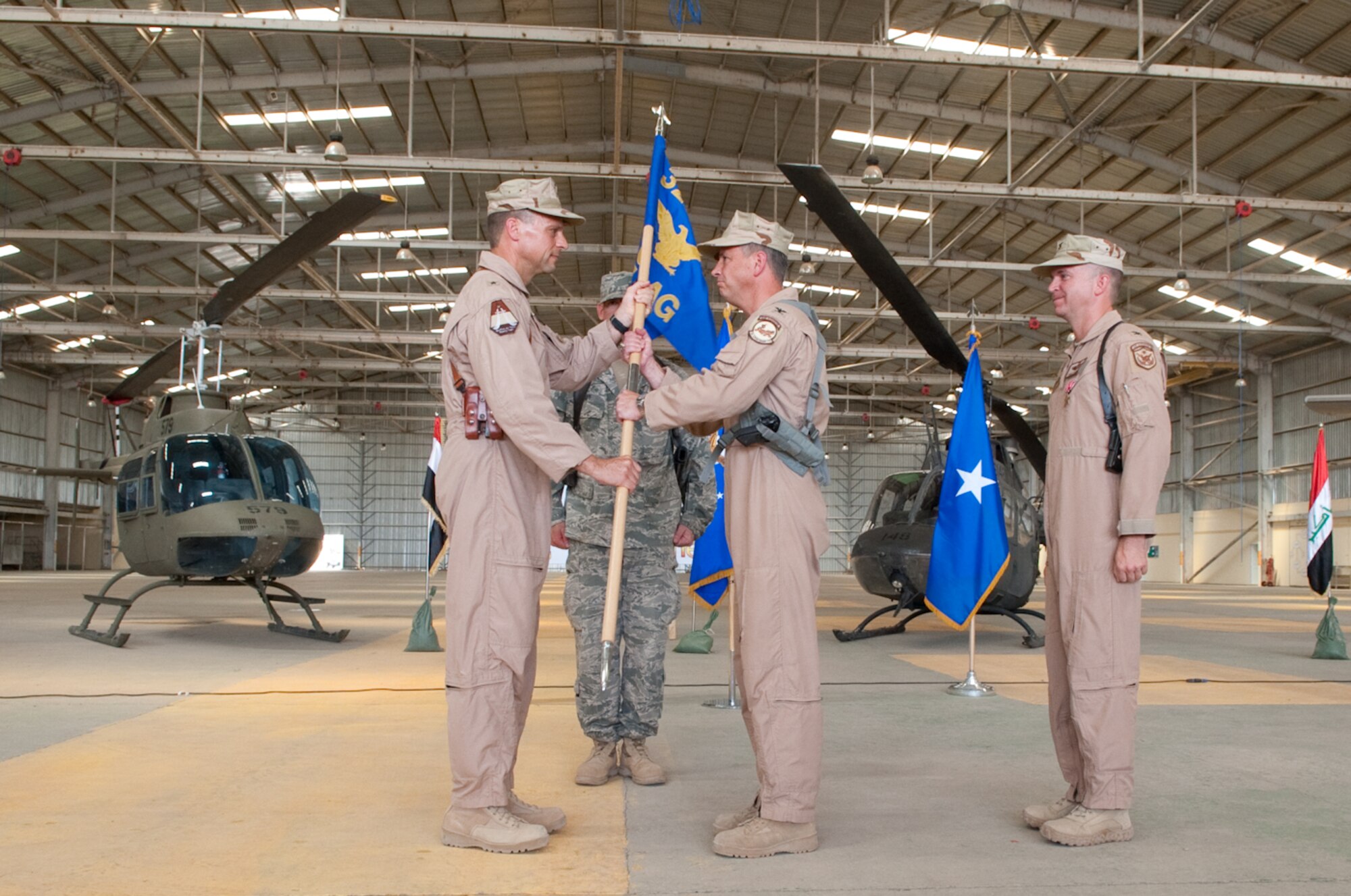 Col. Shaun Turner assumes command of the 321st Air Expeditionary Advisory Group and receives  the guidon from Brig. Gen. Scott Hanson, commander, 321st Air Expeditionary Wing, and director, Iraqi Training Advisory Mission-Air Force, during the change of command ceremony at Kirkuk Regional Air Base, Iraq, June 14, 2010. The group consists of three advisory squadrons, two military training teams and a group staff operating at four locations in Iraq. 