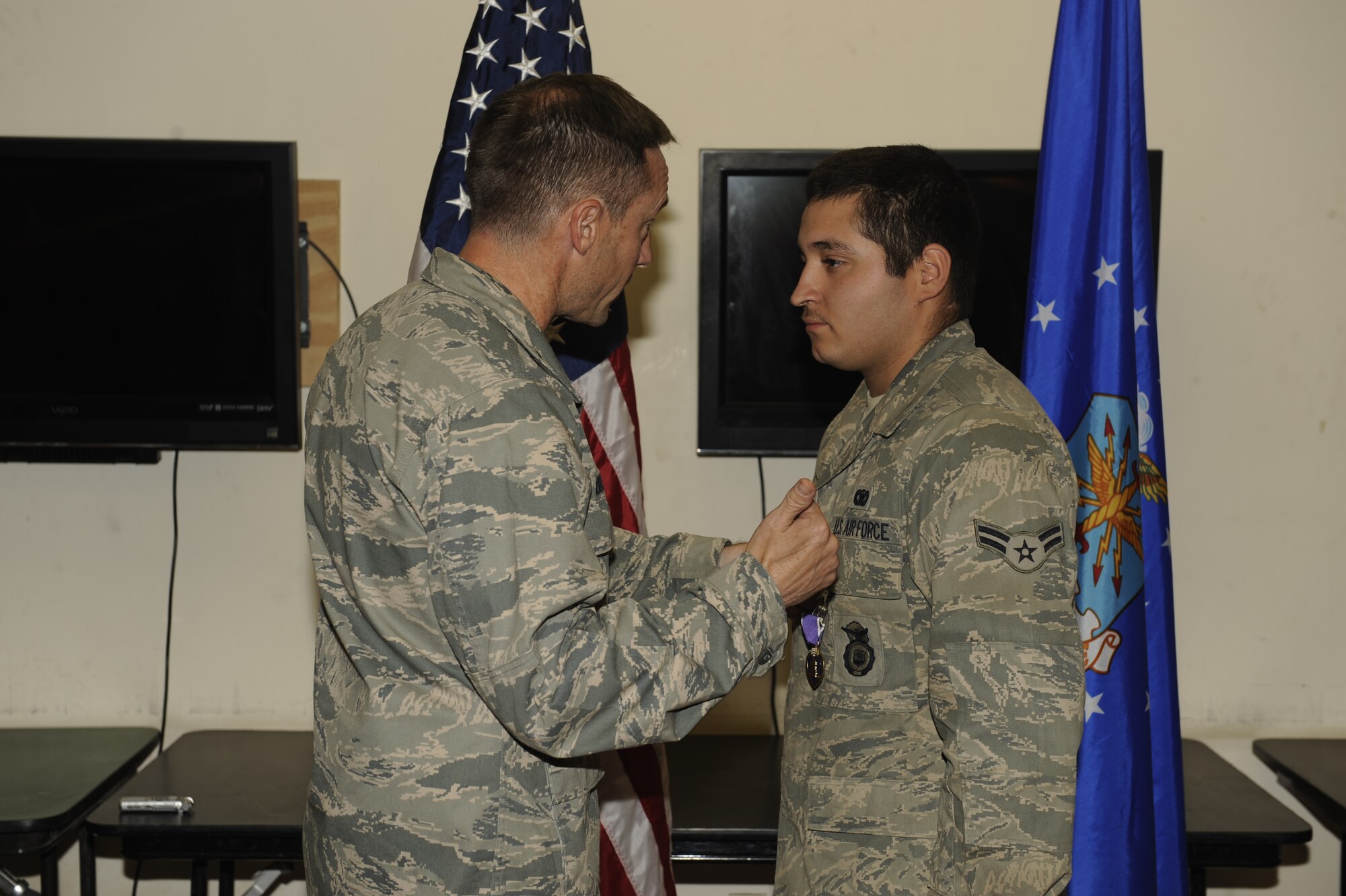 U.S. Air Force Airman 1st Class Giovanni Flores, 455th Expeditionary Security Forces Squadron, receives a Purple Heart Medal from Col. Jack Briggs, 455th Air Expeditionary Wing Commander, during a ceremony at Bagram Airfield, June 11, 2010. Airman Flores is deployed from Tinker Air Force Base, Okla., and is a Dallas, Texas native. (U.S. Air Force photo by/ Master Sgt. Jeromy K. Cross) 
