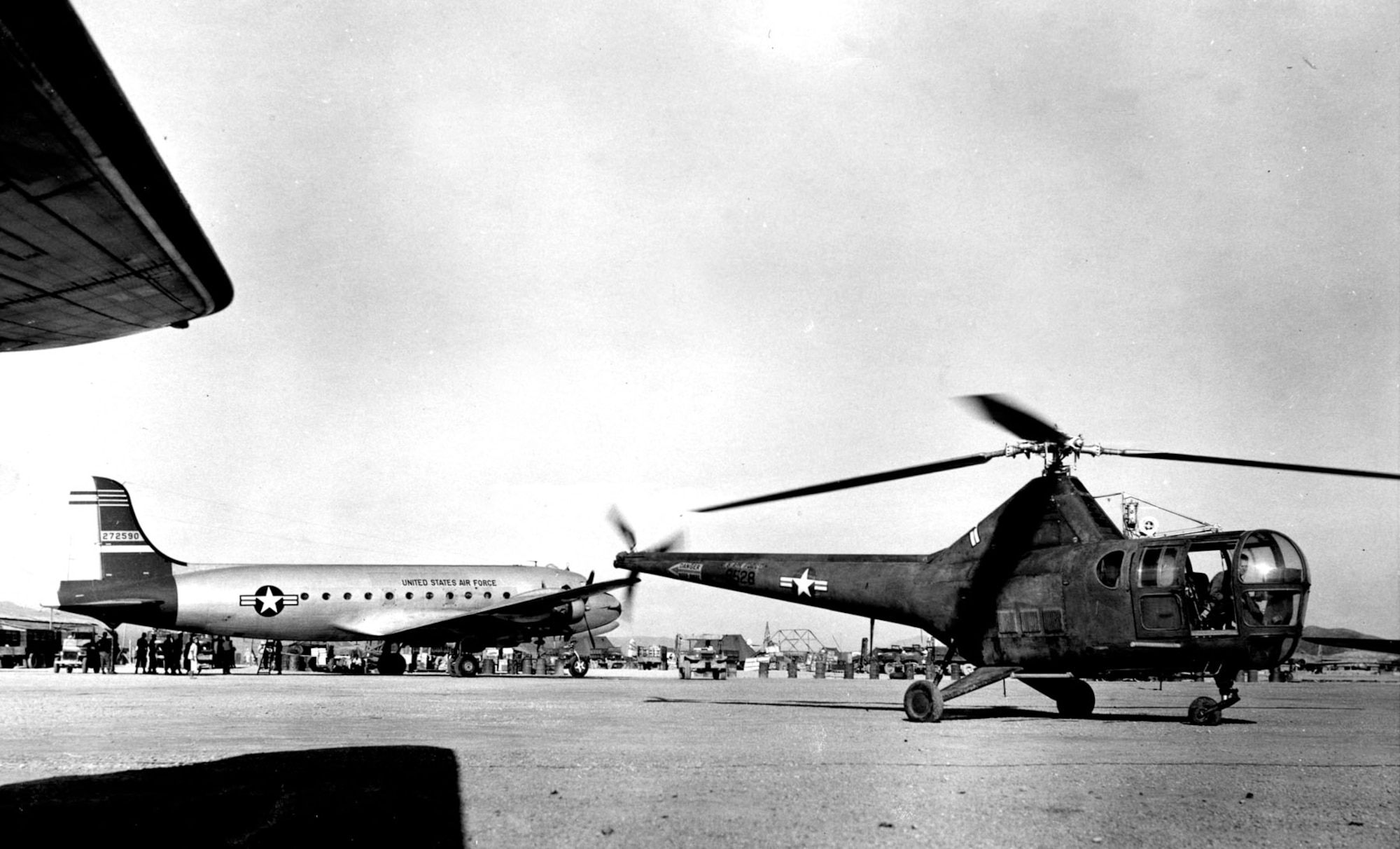 The U.S. Air Force C-54 and the U.S. Air Force H-5 await their next aeromedical evacuation mission during the Korean War. (U.S. Air Force photo)