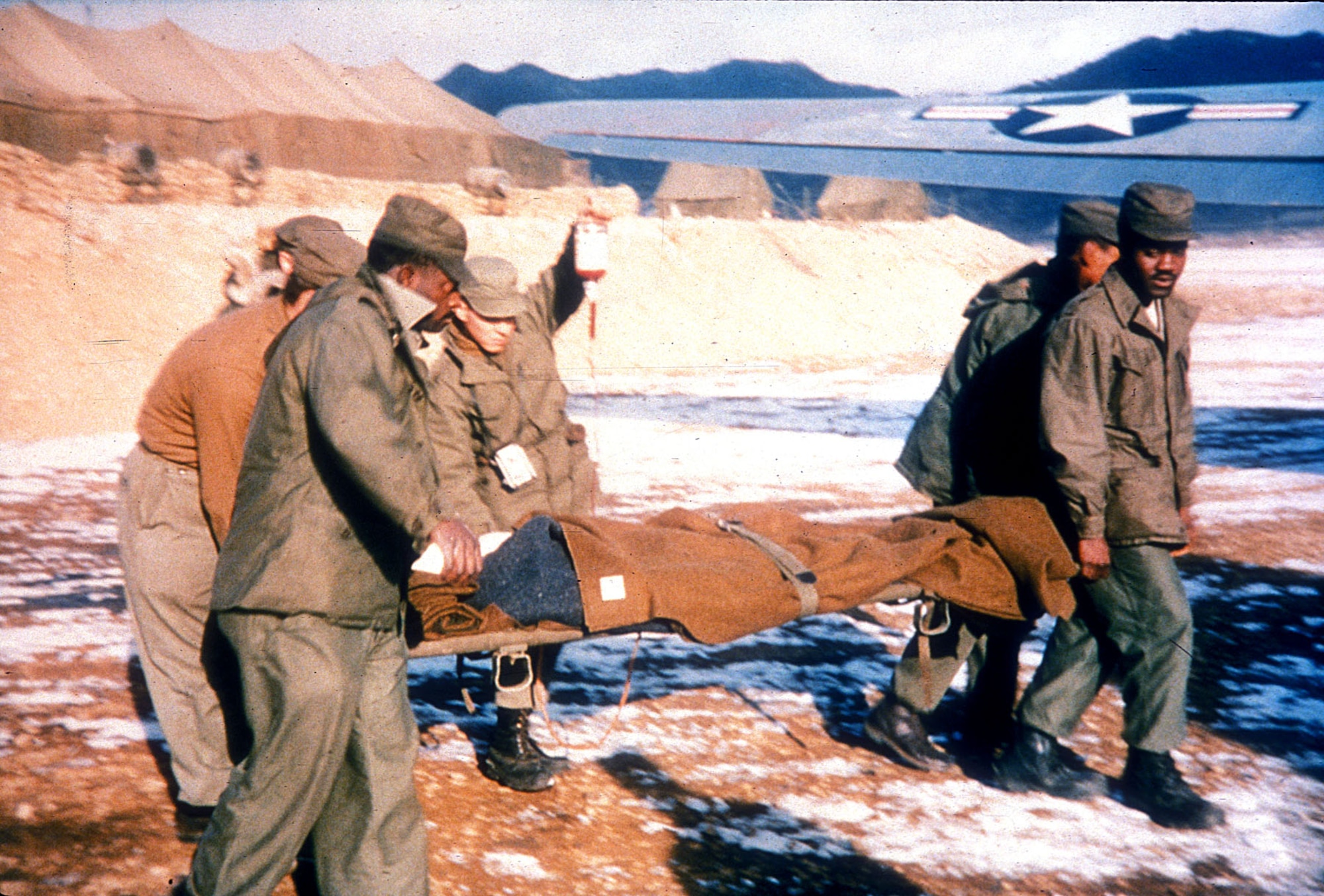 U.S. Airmen move a wounded patient during the Korean War. Speedy evacuation by air cut the casualty death rate by half since World War II. (U.S. Air Force photo)
