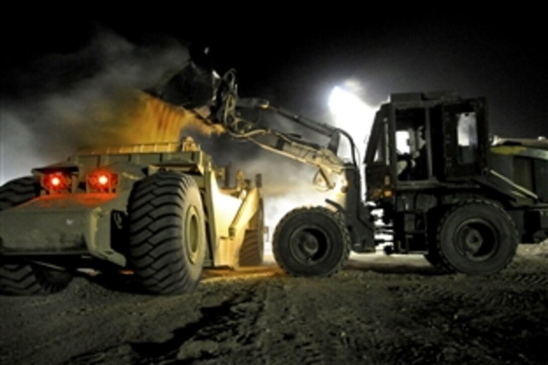 U.S. Navy Petty Officer 3rd Class Jeremy Ott uses a loader to move fill at a project on Camp Leatherneck in Helmand province, Afghanistan, June 16, 2010. Ott is a Seabee assigned to Naval Mobile Construction Battalion 5.