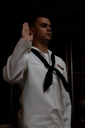 Seaman Apprentice Valentin Shmid, a family practice hospital corpsman, reaffirms his corpsman oath during the 2010 Hospital Corpsman Ball hosted at the Club Iwakuni Eagles Nest here June 18. In closing out the ceremony, all hospital corpsman present at the ball rose to their feet and reaffirmed their oath.