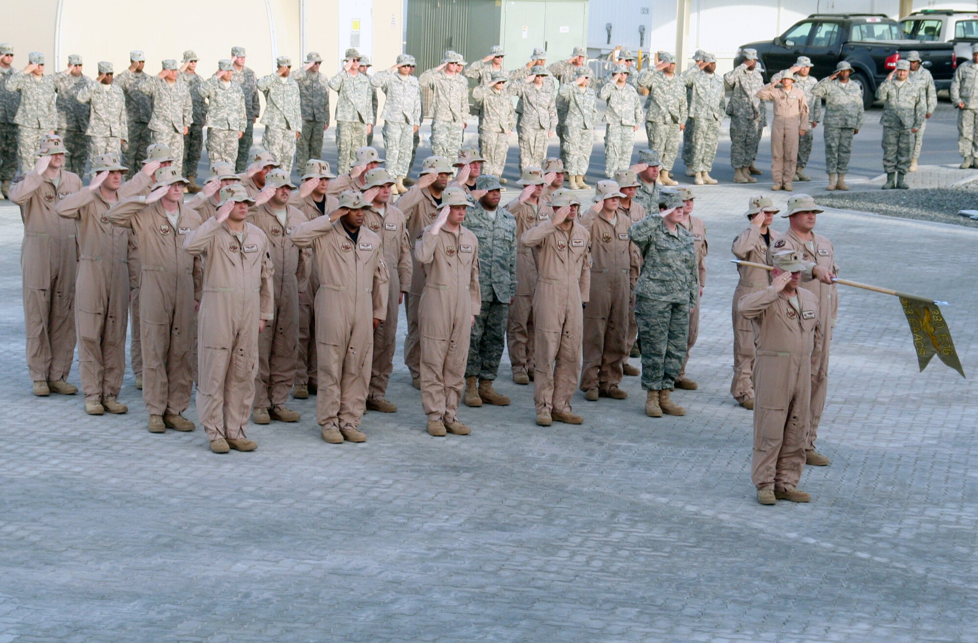 Airmen from the 380th Air Expeditionary Wing participate in a wing-wide retreat ceremony at a non-disclosed base in Southwest Asia on June 11, 2010. Every week the 380th AEW holds a retreat ceremony to honor the American flag and as part of a military tradition. During the June 11 ceremony, the 963rd Expeditionary Airborne Air Control Squadron served as the lead unit in formation. Airmen in the unit are deployed from Tinker Air Force Base, Okla. The 380th AEW supports operations Iraqi Freedom and Enduring Freedom and the Combined Joint Task Force-Horn of Africa. (U.S. Air Force Photo/Master Sgt. Scott T. Sturkol/Released)