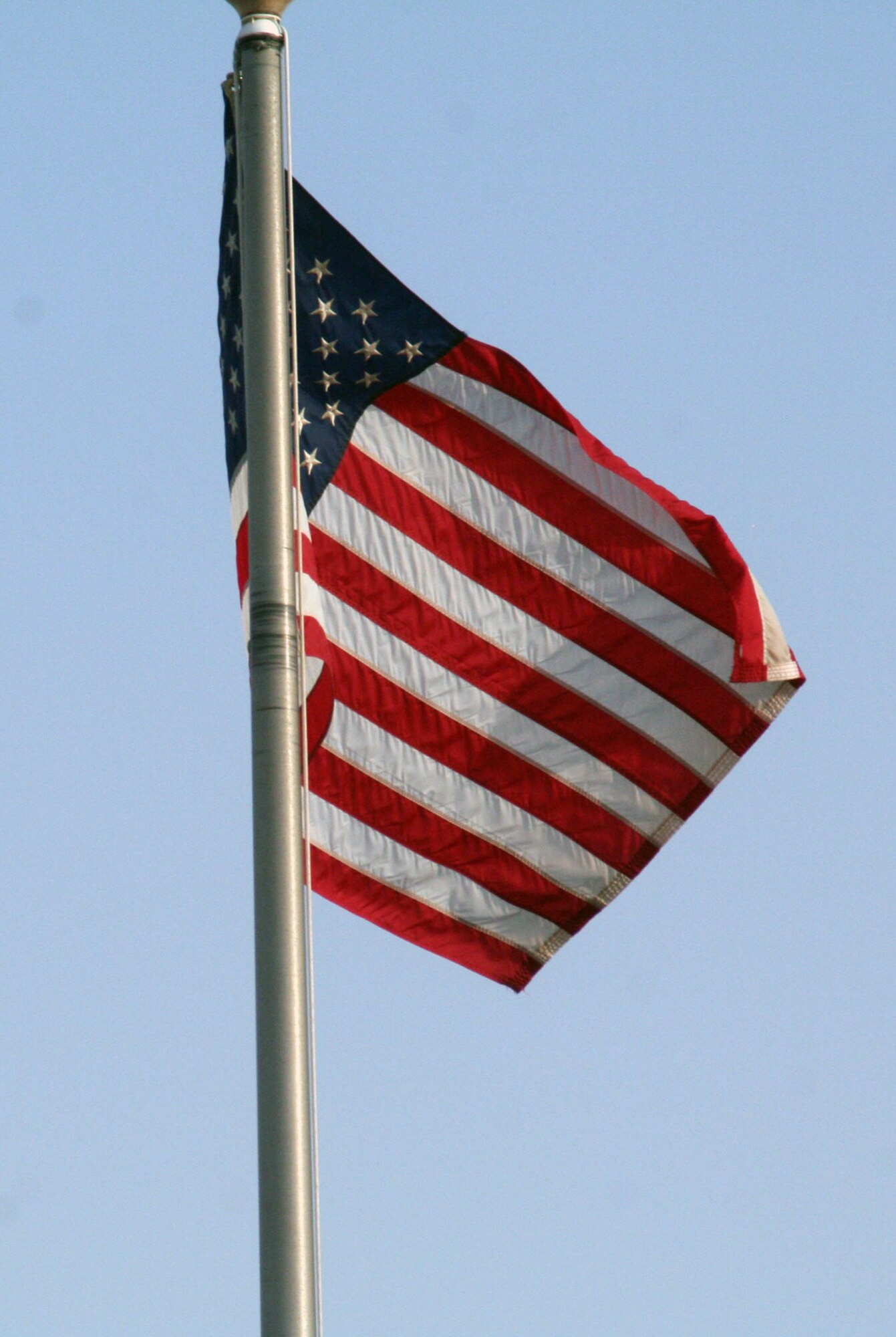 The American flag flies on the wing flag pole while Airmen from the 380th Air Expeditionary Wing participate in a wing-wide retreat ceremony at a non-disclosed base in Southwest Asia on June 11, 2010. Every week the 380th AEW holds a retreat ceremony to honor the American flag and as part of a military tradition. During the June 11 ceremony, the 963rd Expeditionary Airborne Air Control Squadron served as the lead unit in formation. Airmen in the unit are deployed from Tinker Air Force Base, Okla. The 380th AEW supports operations Iraqi Freedom and Enduring Freedom and the Combined Joint Task Force-Horn of Africa. (U.S. Air Force Photo/Master Sgt. Scott T. Sturkol/Released)