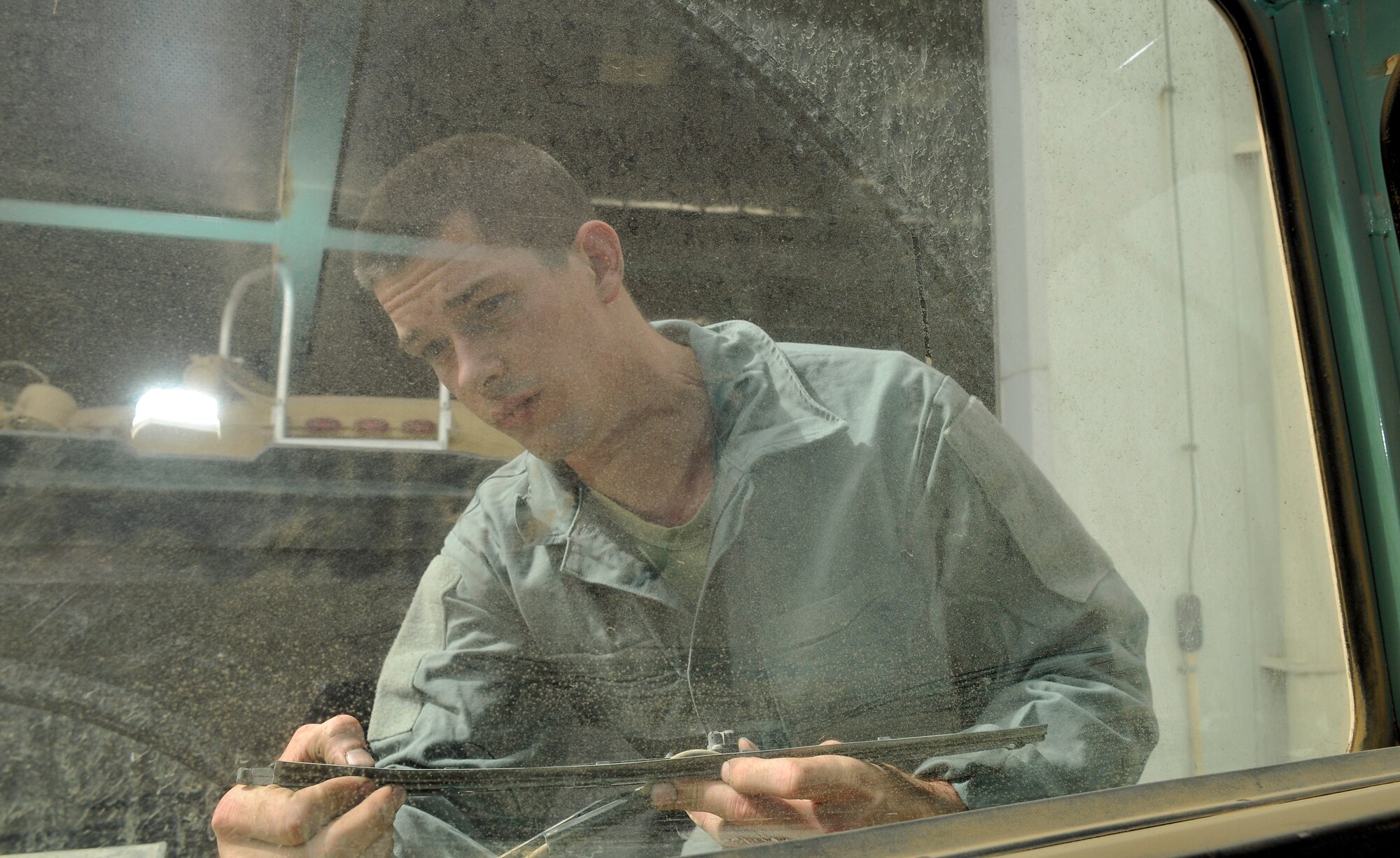 Airman 1st Class Joseph Martincic, 332nd Expeditionary Logistics Readiness Squadron Refueling Maintenance Shop vehicle maintenance technician, checks a windshield wiper for fraying as part of a safety inspection June 18, 2010, Joint Base Balad, Iraq. The RMS works on all aircraft refueling vehicles. Airman Martincic  is deployed from Ellsworth Air Force Base, S.C. (U.S. Air Force photo\Staff Sgt. Phillip Butterfield)