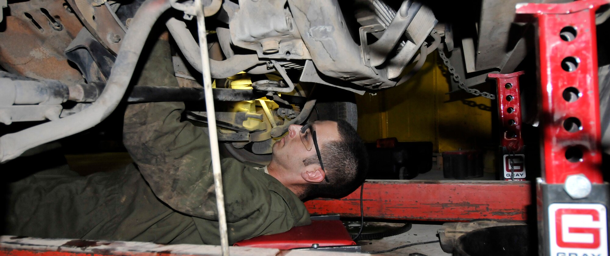 Senior Airman Christopher Grossman, 332nd Expeditionary Logistics Readiness Squadron Special Purpose Shop vehicle maintenance technician, aligns motor mounts for a Bobtail’s engine installation June 16, 2010, Joint Base Balad, Iraq. One of the vehicles the SPS repairs is the Bobtail truck, which is used to pull equipment on the flightline. Airman Grossman is deployed from Ramstein Air Base, Germany. (U.S. Air Force photo\Staff Sgt. Phillip Butterfield)