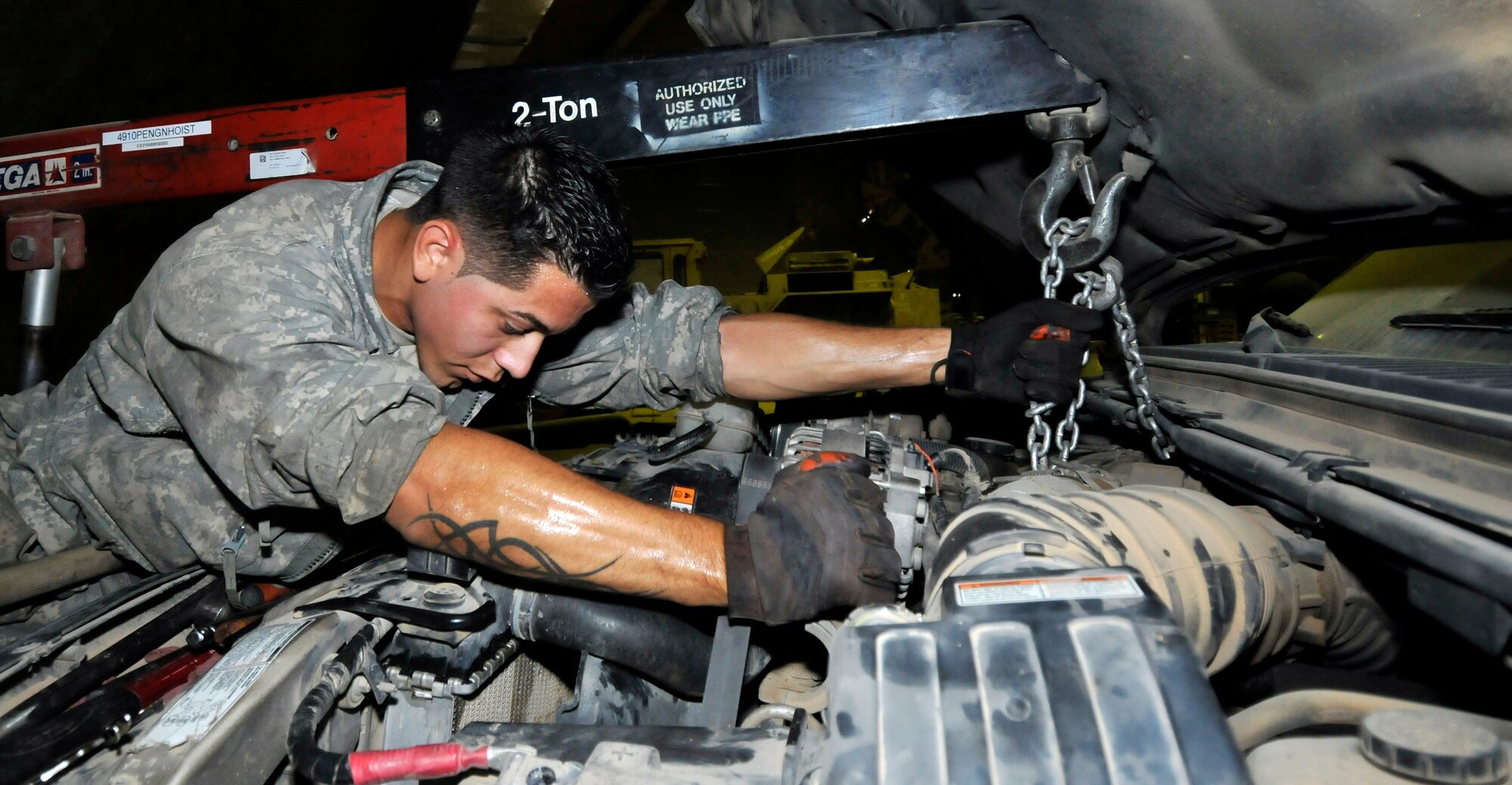 Senior Airman Thomas Burright, 332nd Expeditionary Logistics Readiness Squadron Special Purpose Shop vehicle maintenance technician, positions a Bobtail’s engine for installation June 16, 2010, Joint Base Balad, Iraq. The Airman of the SPS are equipped to repair any vehicular malfunction. Airman Burright is deployed from Ramstein Air Base, Germany. (U.S. Air Force photo\Staff Sgt. Phillip Butterfield)