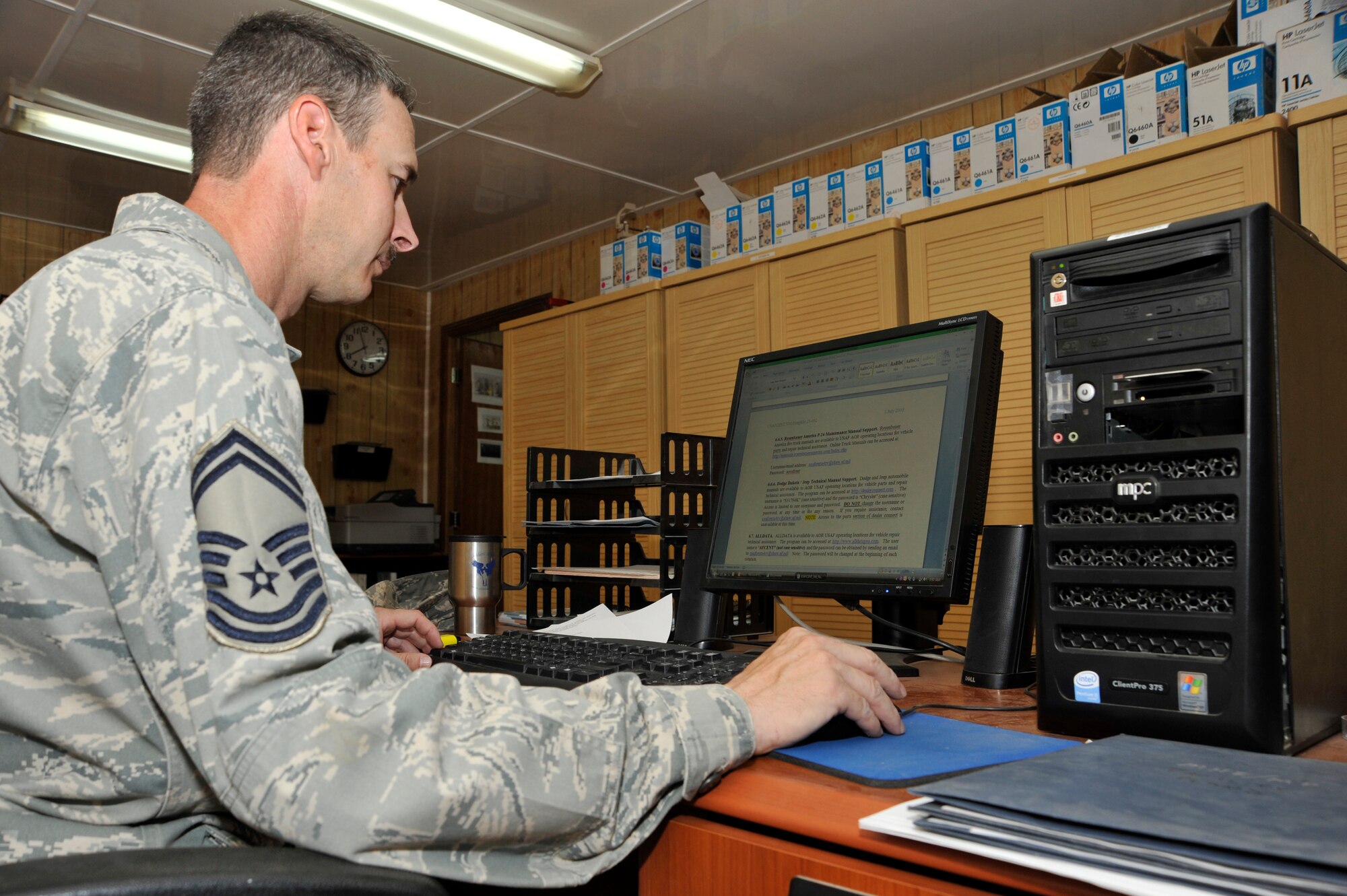 Senior Master Sgt. CJ Slifko, 447th Expeditionary Logistics Readiness Squadron, vehicle fleet manager, deployed from McConnell Air Force Base, Kan., looks over the U.S. Air Forces Central vehicle maintenance Air Force Instruction June 19, 2010, at Sather Air Base, Iraq. Sergeant Slifko's son joined the Air Force and entered the same career field, and deployed to the same unit as his father. (U.S. Air Force photo by Senior Airman Perry Aston/Released)