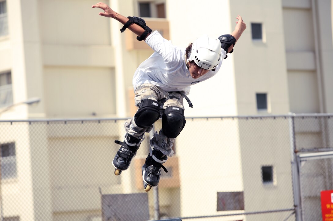 Blader, Kyle Allen, 13, shreds up the air during the King of the Ring Skate Park competition Sunday on Camp Courtney. Allen and other competitors are required to wear personal protective equipment such as helmets, elbow pads, kneepads and wrist guards when using the skate park.