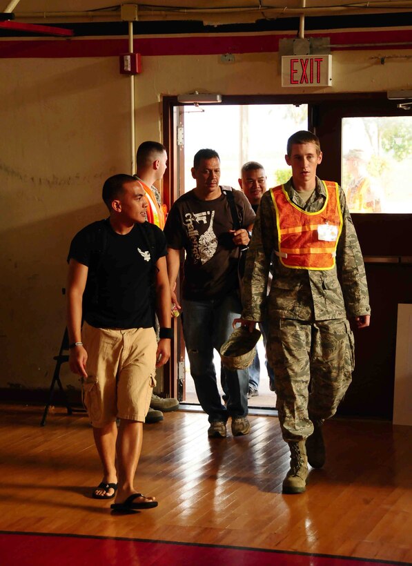 ANDERSEN AIR FORCE BASE, Guam ? Members of Team Andersen acting as role players arrive to the Noncombatant Evacuee Operation processing area, here June 8. The NEO was part of larger scenario during the Operational Readiness Inspection, which is designed to test Andersen?s mission capabilities. (U.S. Air Force photo by Airman 1st Class Jeffrey Schultze)