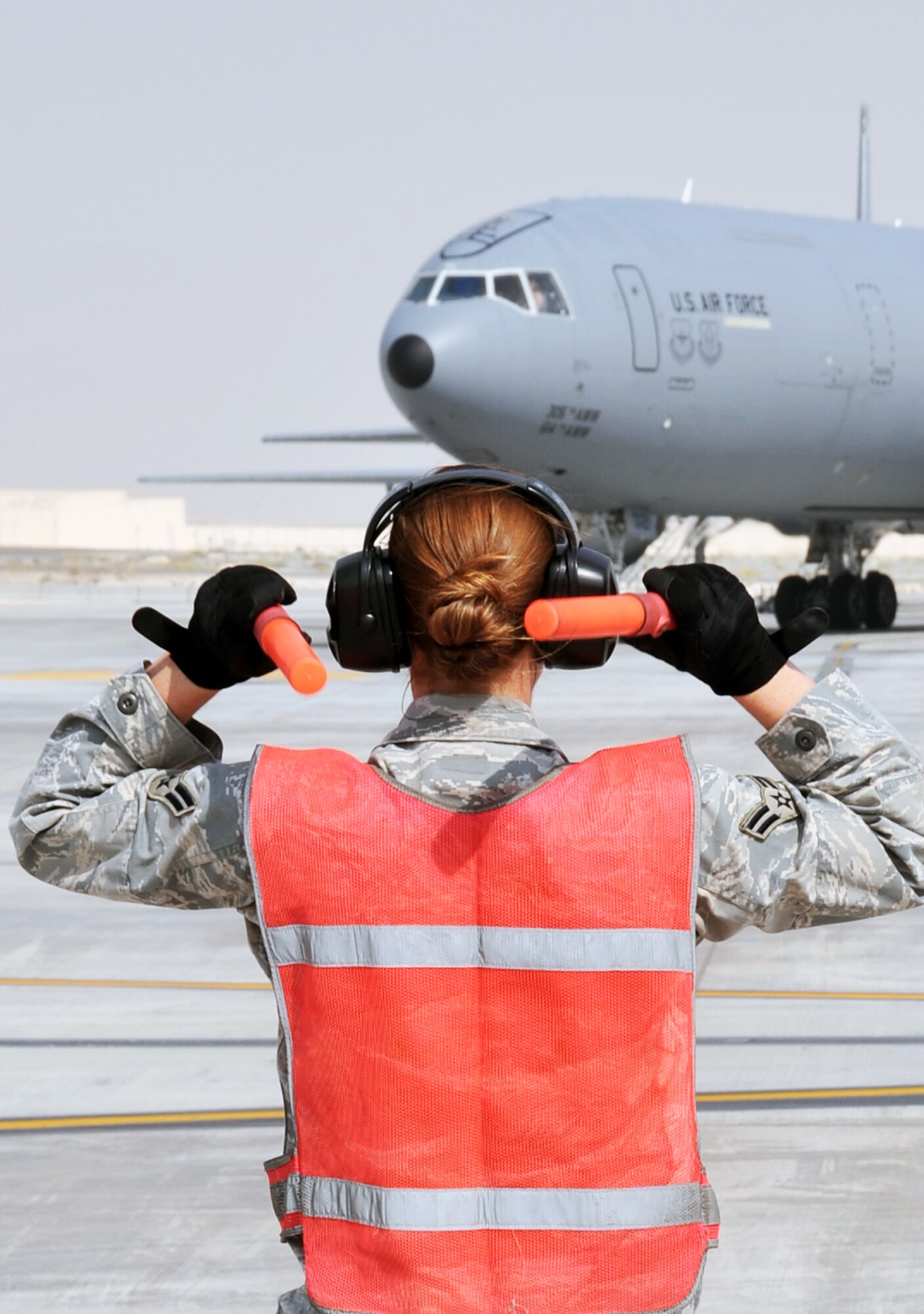 A maintenance Airman from the 380th Expeditionary Aircraft Maintenance Squadron's Extender aircraft maintenance unit provides direction to the flight crew of the KC-10 Extender from the 908th Expeditionary Air Refueling Squadron during flightline operations for the 380th Air Expeditionary Wing at a non-disclosed base in Southwest Asia on June 7, 2010. The 380th AEW supports operations Iraqi Freedom and Enduring Freedom and the Combined Joint Task Force-Horn of Africa. (U.S. Air Force Photo/Master Sgt. Scott T. Sturkol/Released)