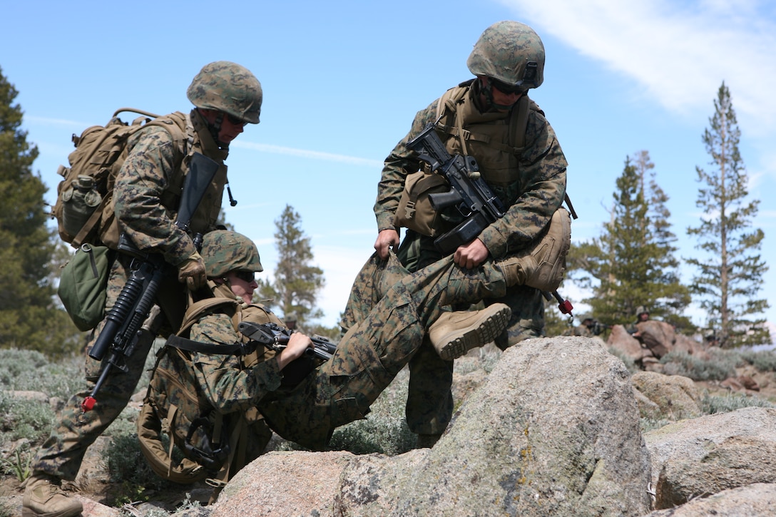 Marines with 1st Battalion, 25th Marine Regiment carry a simulated casualty after being ambushed by a mock enemy force.