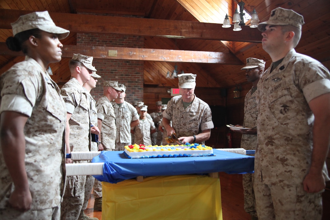 Maj. Gen. James F. Flock, commanding general of 2nd Marine Aircraft Wing, cuts the first piece of cake during the Navy Hospital Corps’ Birthday ceremony at Hancock Lodge, June 21. Hospital corpsmen, who observe their birthday on June 17, have served with distinction alongside Marines in every clime and place since 1898.