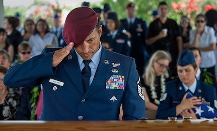 Master Sgt. Mike Maroney, renders a salute after removing the flash from his pararescue beret  and leaving it on the casket of  his fallen comrade, Tech. Sgt. Michael Flores who died June 9, near FOB Jackson, Afghanistan, in a HH-60G Pave Hawk helicopter crash. Since Sept. 11, 2001, U.S. Air Force Pararescueman have begun the tradition of leaving their beret flashes to their fallen "PJs" as a sign of honor and respect. The beret and flash are the cherished items of a pararescueman has it takes two years of training to earn. 
(U.S. Air Force photo/Staff Sgt. Bennie J. Davis III)