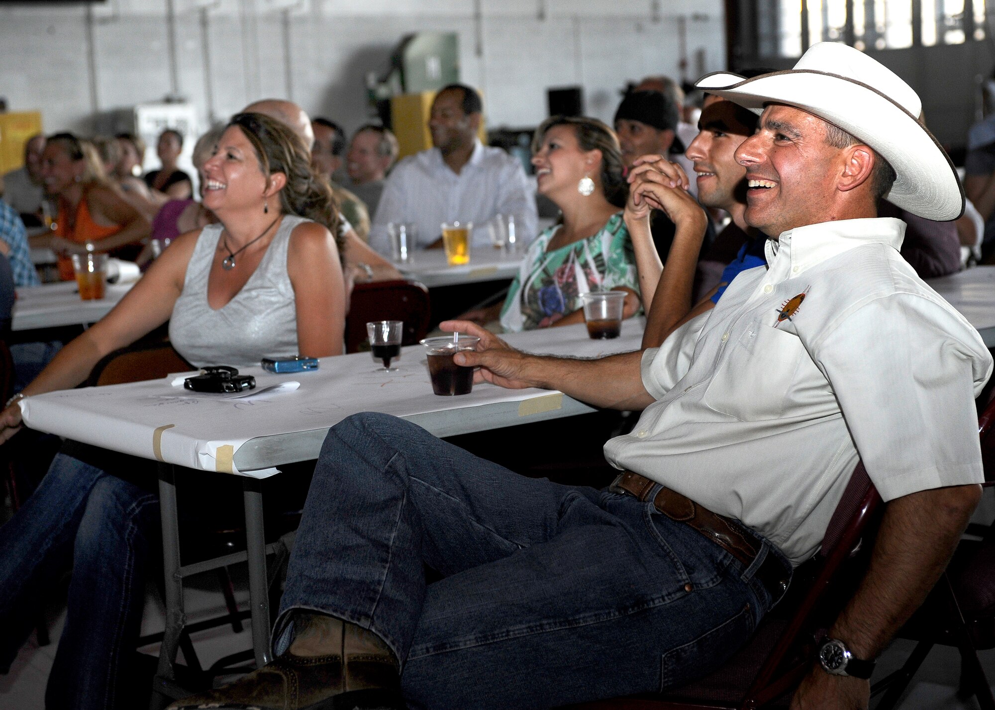 HOLLOMAN AIR FORCE BASE, N.M. -- Col. Jeff Harrigian, 49th Fighter Wing commander, sits back with his family and friends while watching a slideshow presentation during his "Cowboy Cook-Out" farewell dinner June 18, 2010. Squadron leaders and representatives from different organizations on base shared stories about Colonel Harrigian and presented him with gifts. (U.S. Air Force photo by Senior Airman Veronica Stamps / Released)