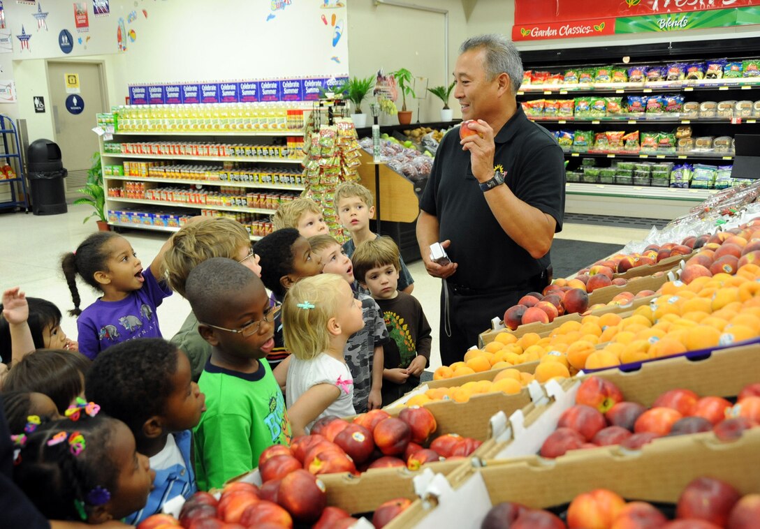 Children from the Los Angeles AFB Child Development Center learn about eating healthy fruits and veggies during a visit to the base commissary, June 17.  (Photo by Lou Hernandez)