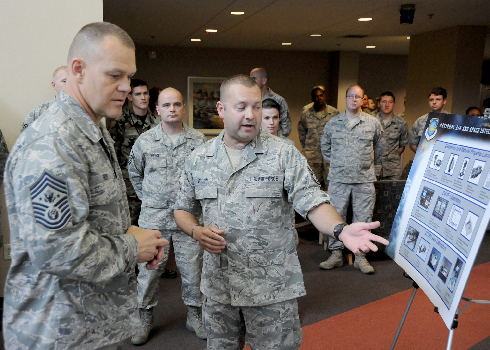 Chief Master Sgt. of the Air Force James A. Roy discusses foreign material exploitation with Tech. Sgt. Douglas Brown during his tour of the National Air and Space Intelligence Center  June 11, 1020, at Wright-Patterson Air Force Base, Ohio. (U.S. Air Force photo/Staff Sgt. Joshua Strang)