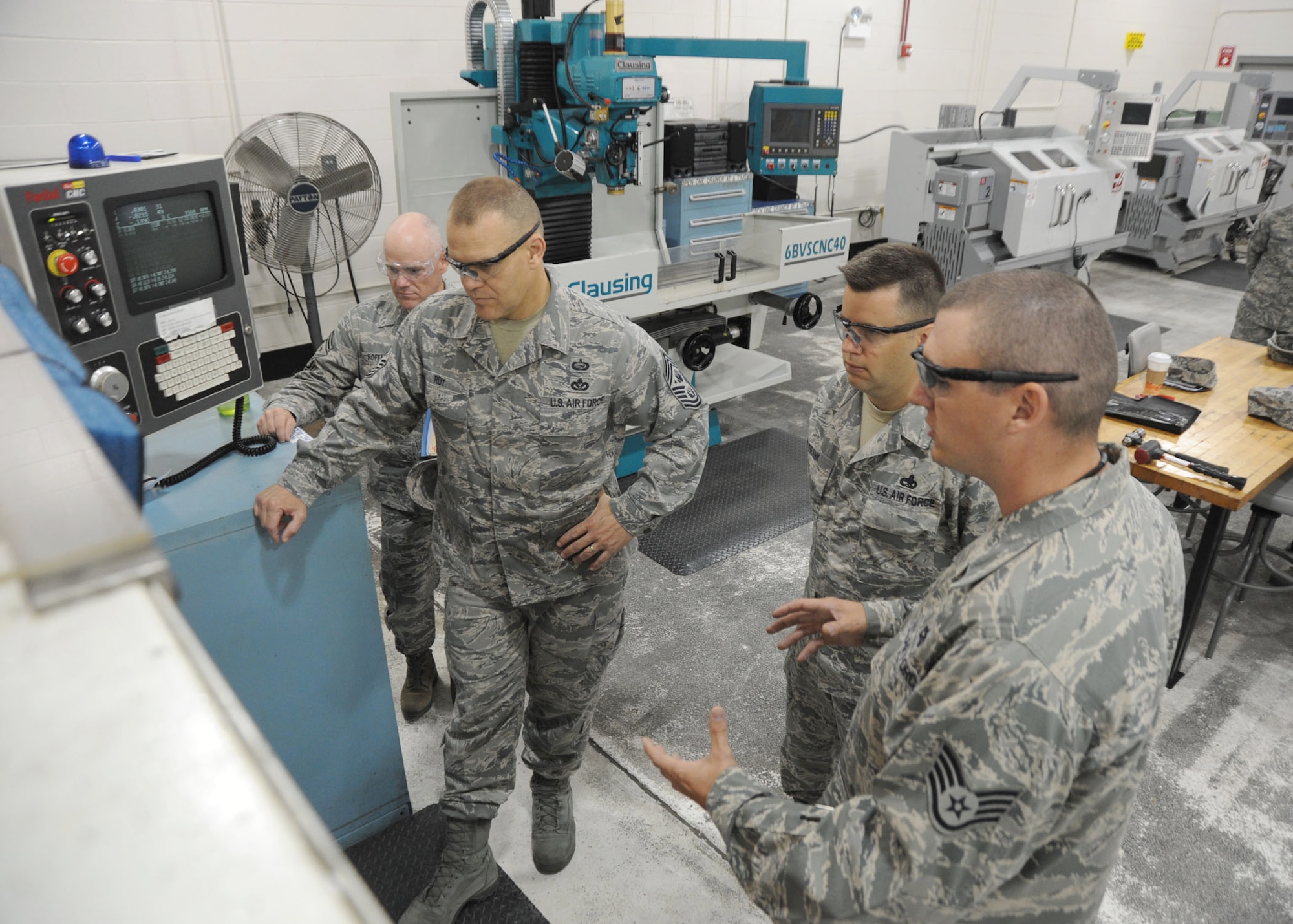 Chief Master Sgt. of the Air Force James A. Roy watches as Staff Sgt. Michael Foster demonstrates the part fabrication capabilities of the 445th Airlift Wing June 11, 2010, at Wright-Patterson Air Force Base, Ohio. (U.S. Air Force photo/Staff Sgt. Joshua Strang)