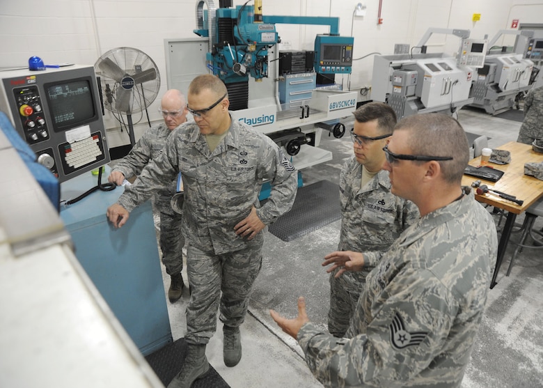 Chief Master Sgt. of the Air Force James A. Roy watches as Staff Sgt. Michael Foster demonstrates the part fabrication capabilities of the 445th Airlift Wing June 11, 2010, at Wright-Patterson Air Force Base, Ohio. (U.S. Air Force photo/Staff Sgt. Joshua Strang)