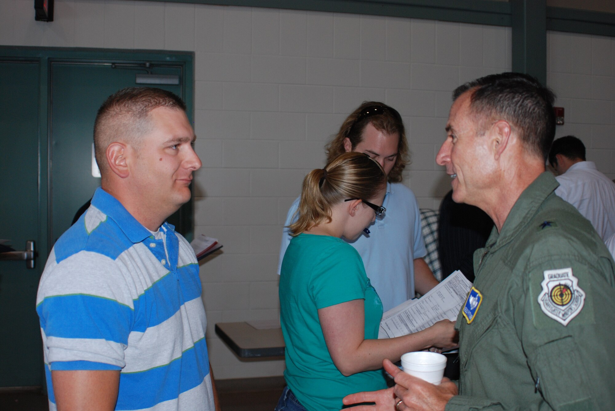 Brig. General Kevin Pottinger (right), Air Reserve Personnel Center
commander and former 301st Fighter Wing commander, was in attendance June 12
at Naval Air Station Fort Worth Joint Reserve Base, Texas, to show support
for the first joint Reserve mass muster for the Individual Ready Reserve. He
spoke to IRR members during the event, including Lucas Smith, who has been
on IRR for three years.