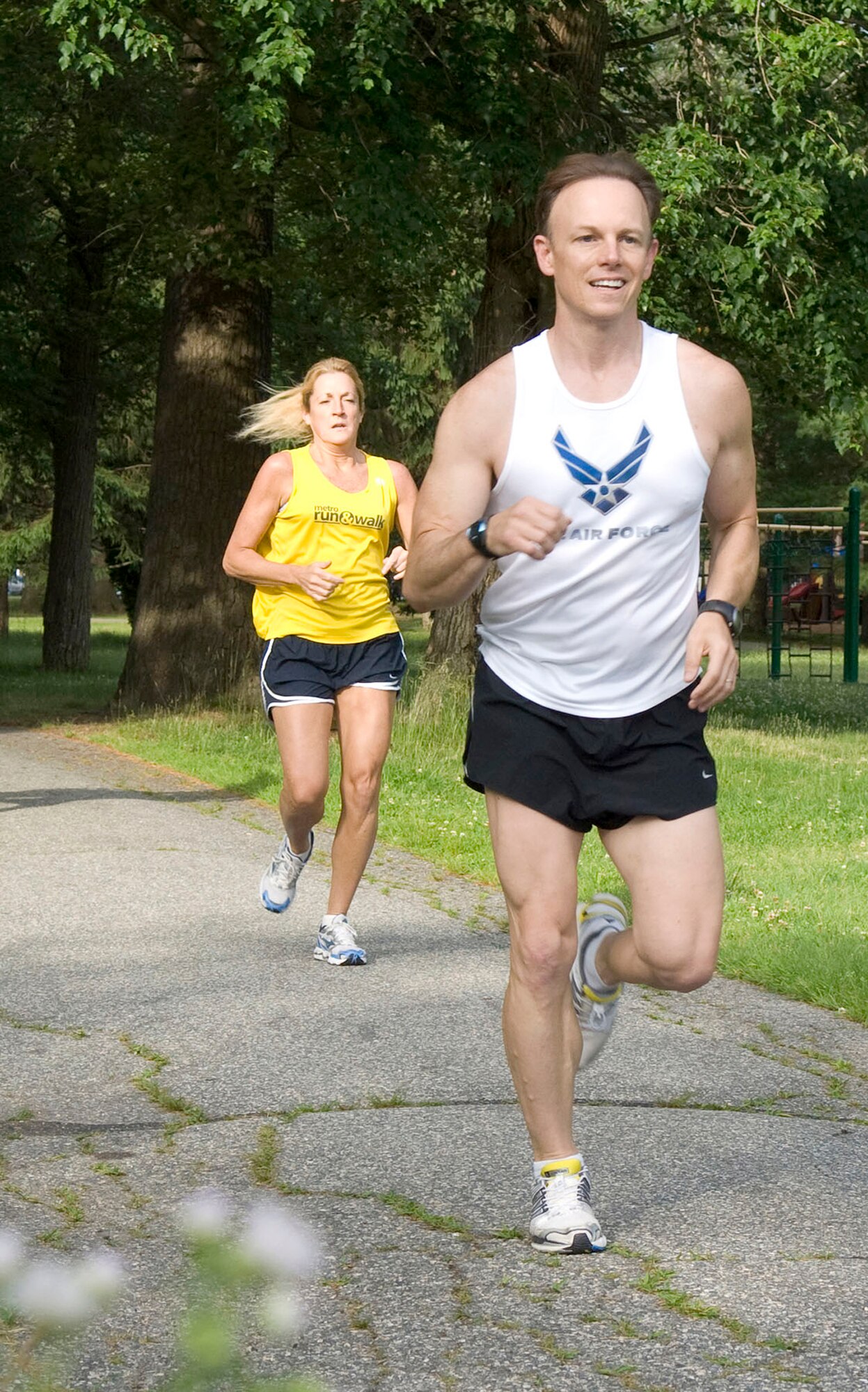 Col. Mary McRae (left) and Maj. (Dr.) Derek Speten run in the Summer Thunder 10K race, which began and finished at the Fitness and Sports Center June 16, 2010, at Hanscom Air Force Base, Mass. Colonel McRae is the Electronic Systems Center chief of staff. Doctor Speten is the 66th Medical Group Diagnostics and Therapeutics flight commander. (U.S. Air Force photo/Mark Wyatt)
